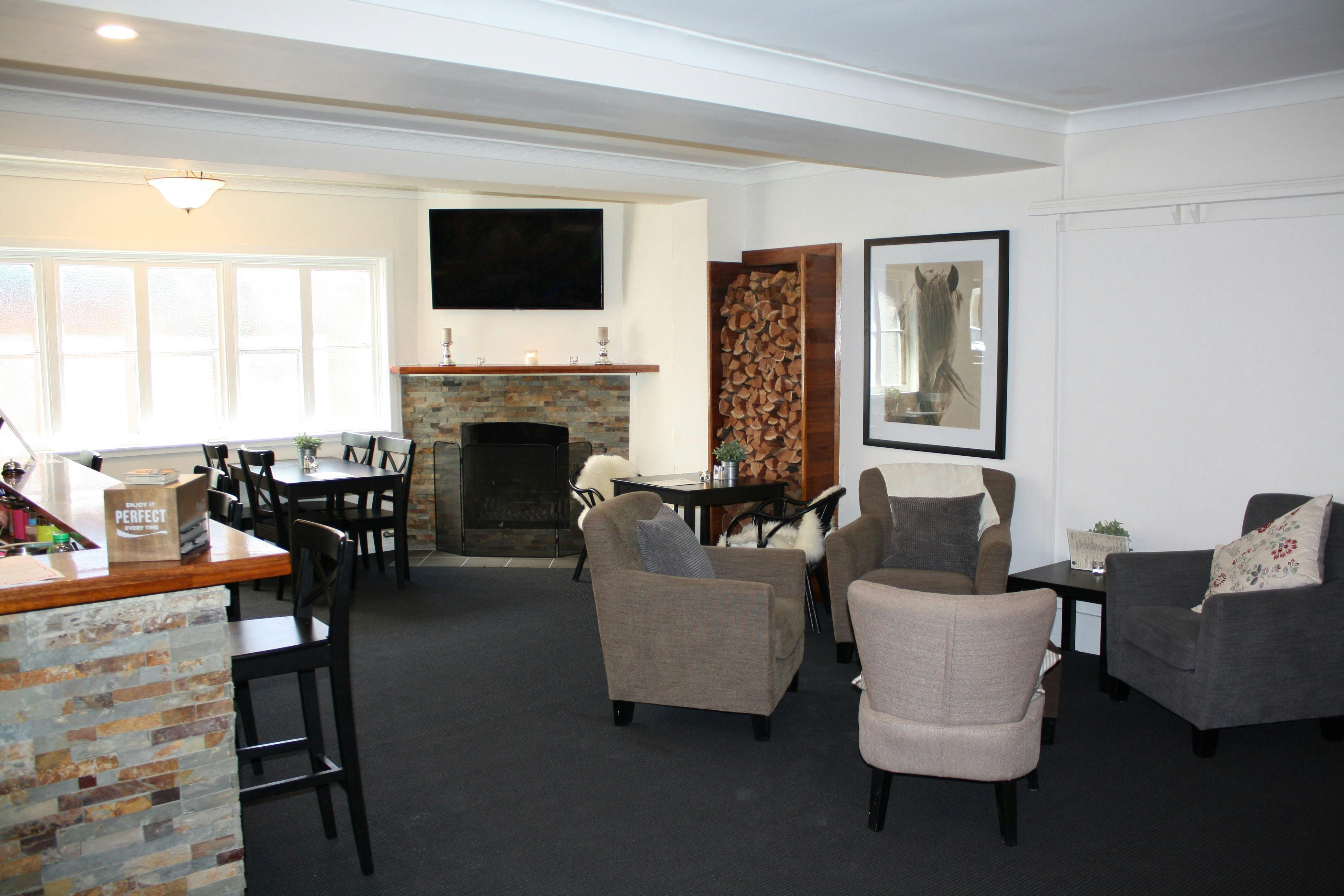 Lounge bar with comfortable seating, fireplace and television