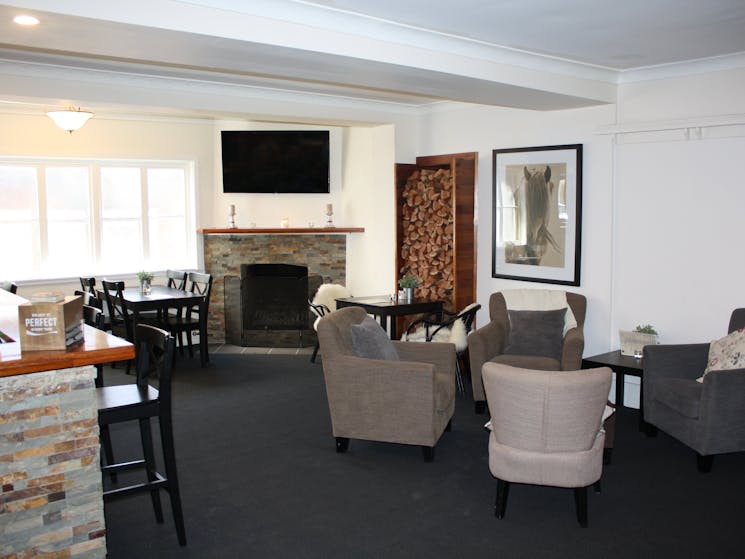 Lounge bar with comfortable seating, fireplace and television