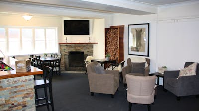 Lounge bar with comfortable seating, fireplace and television