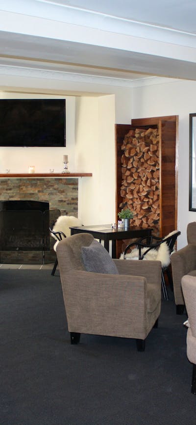 Lounge bar with comfortable seating, fireplace and television