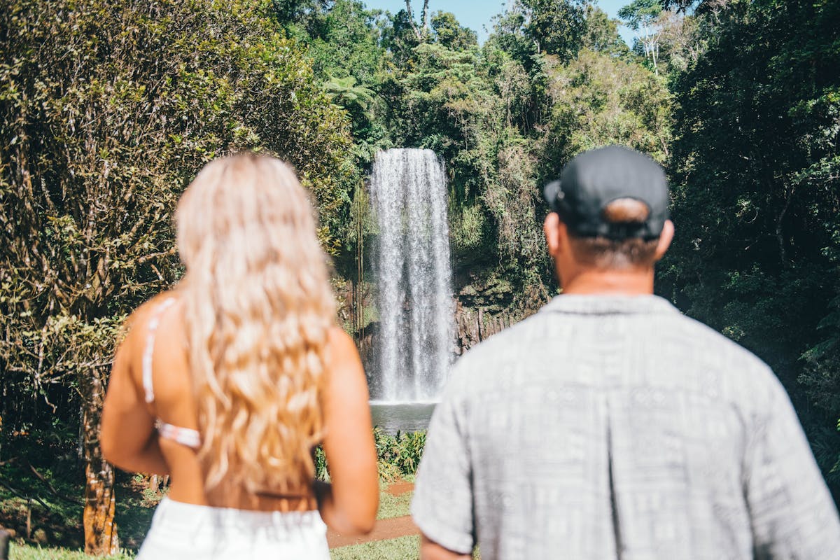 Couple stands with their backs to the camera as the stare at Millaa Millaa on Atherton Tablelands