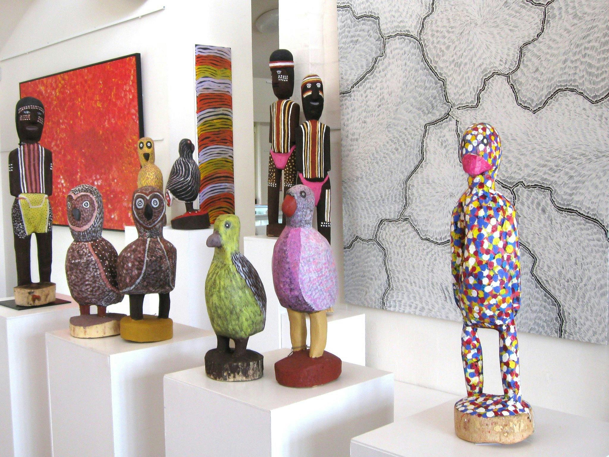 Large carved birds and ceremonial figures by Utopia artists, Aboriginal art paintings.