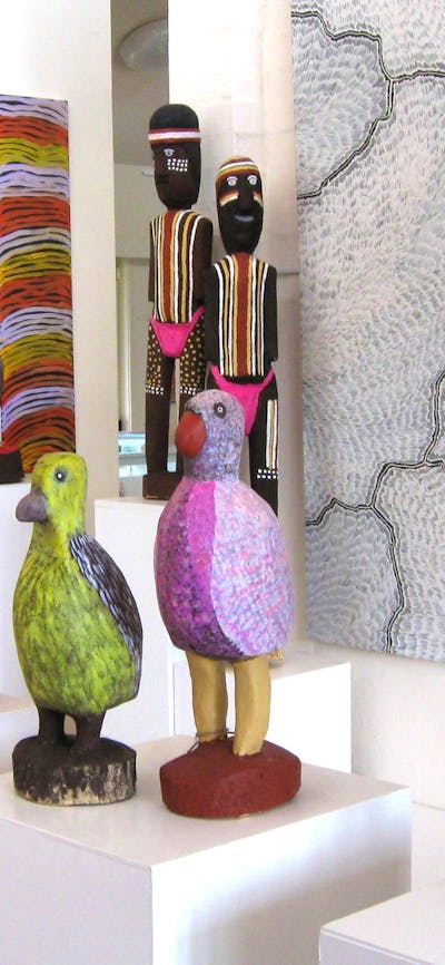 Large carved birds and ceremonial figures by Utopia artists, Aboriginal art paintings.
