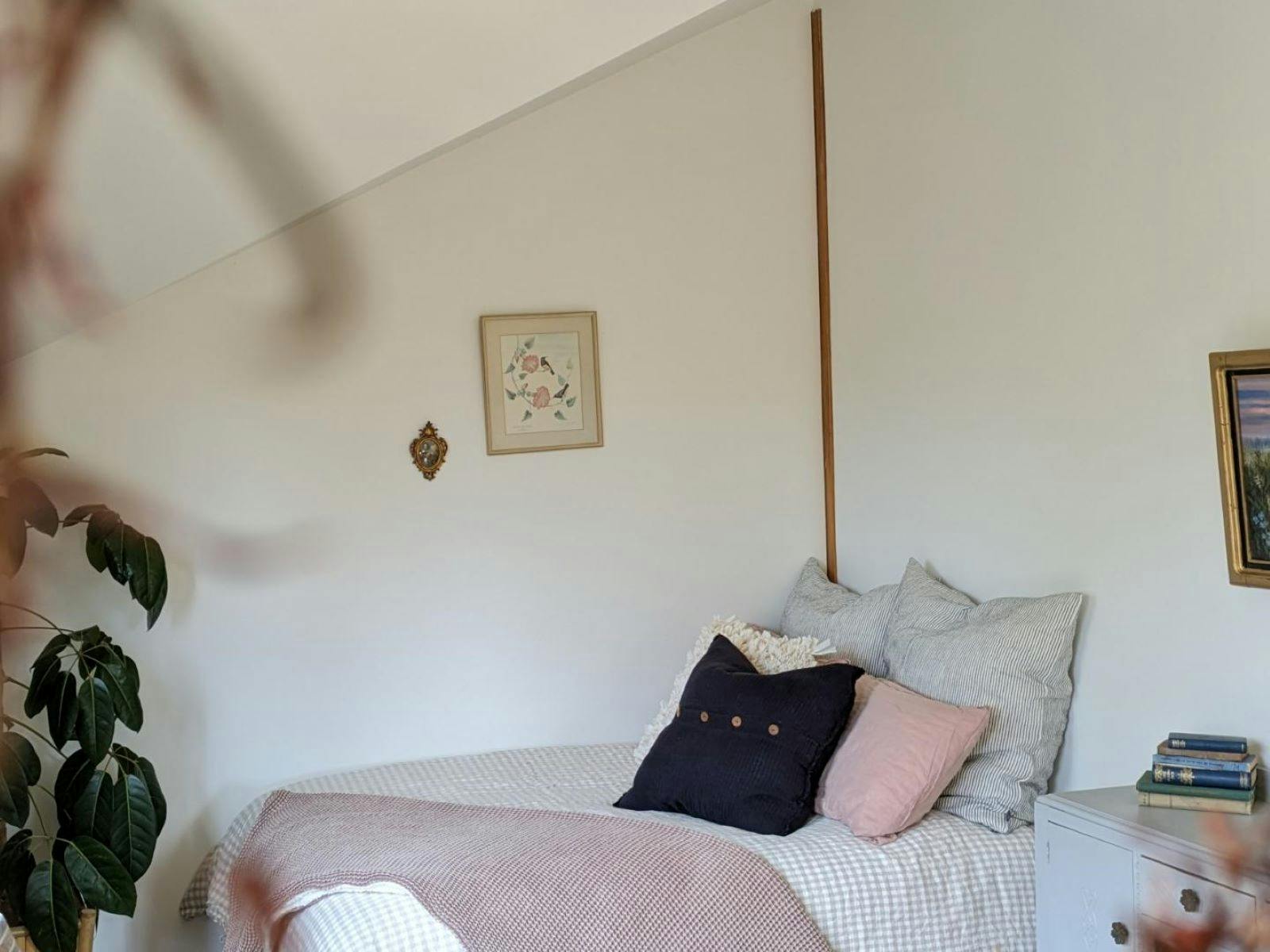 Luxury linens drapped over a bed with cushions and throws in a cute corner of the cabin