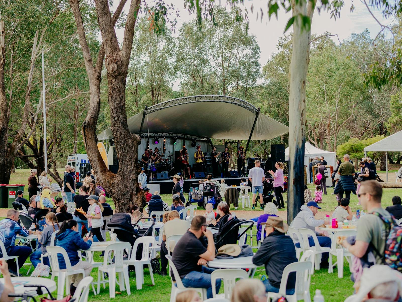 Event attendees sitting at tables in front of the main stage