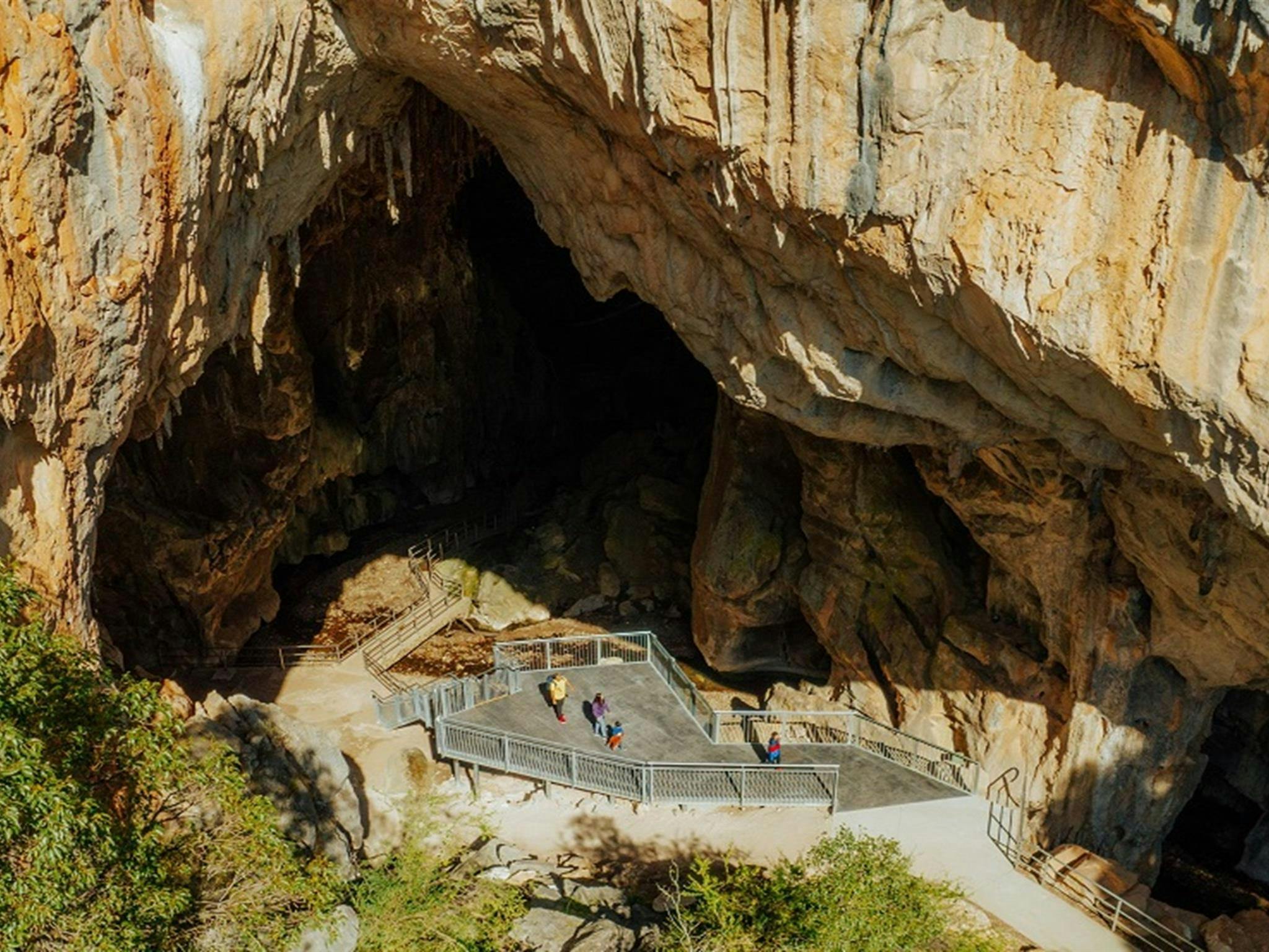 Aerial view of a family group about to enter Victoria Arch, the last chamber of Fig Tree Cave at