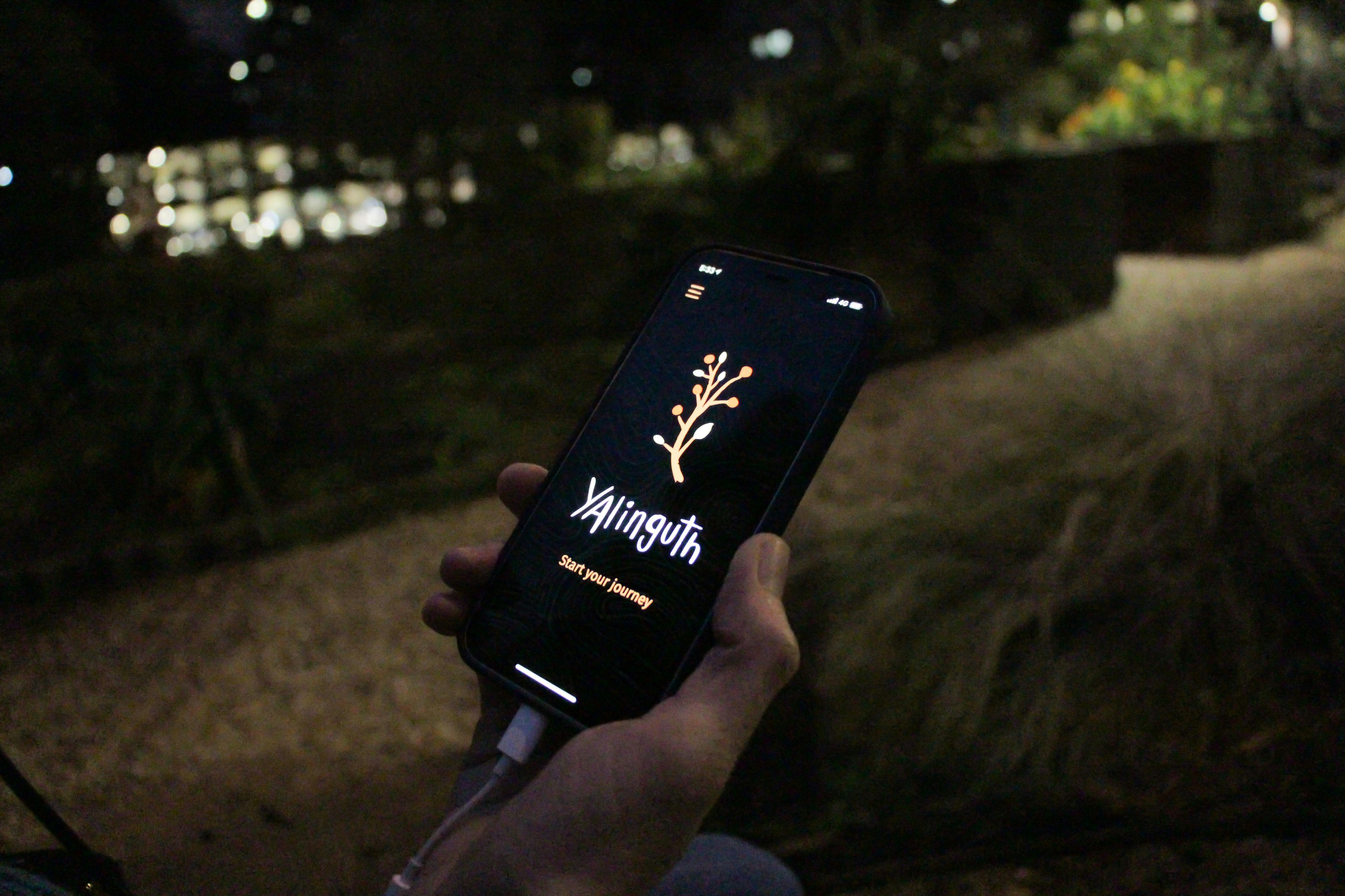 Listening to the Yalinguth App at the Stolen Generations Marker, Atherton Gardens, Fitzroy