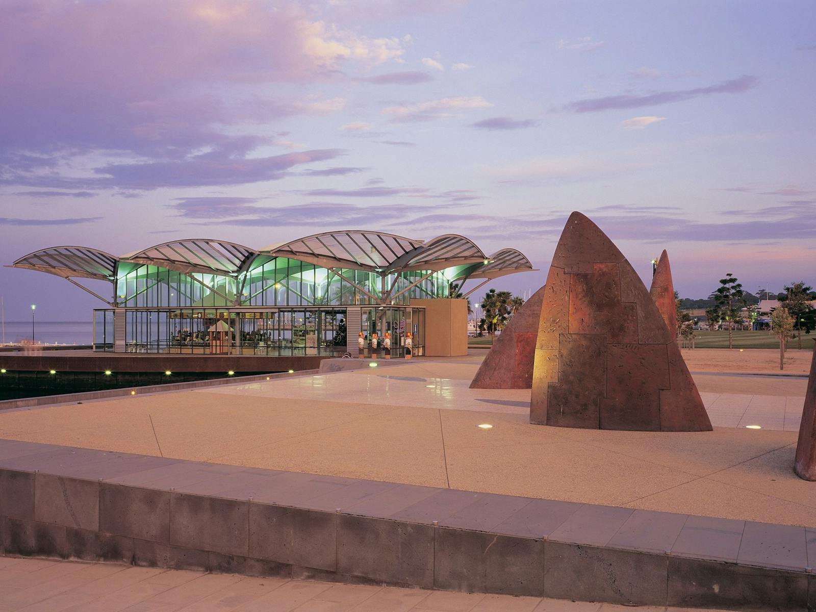 A photo of The Carousel and North sculpture on the Waterfront at sunset.