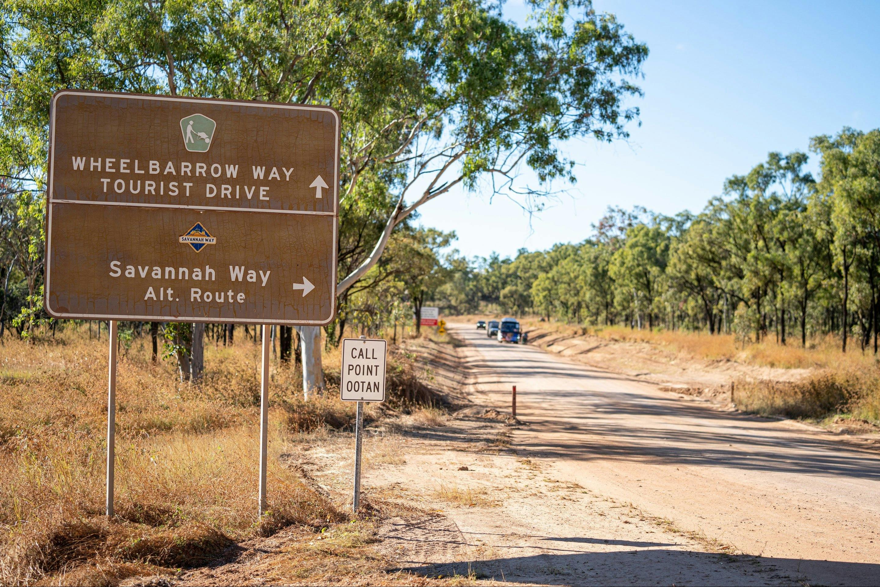 Cars wait on the side of the dirt rod along Wheelbarrow Way, Mareeba Shire, FNQ.