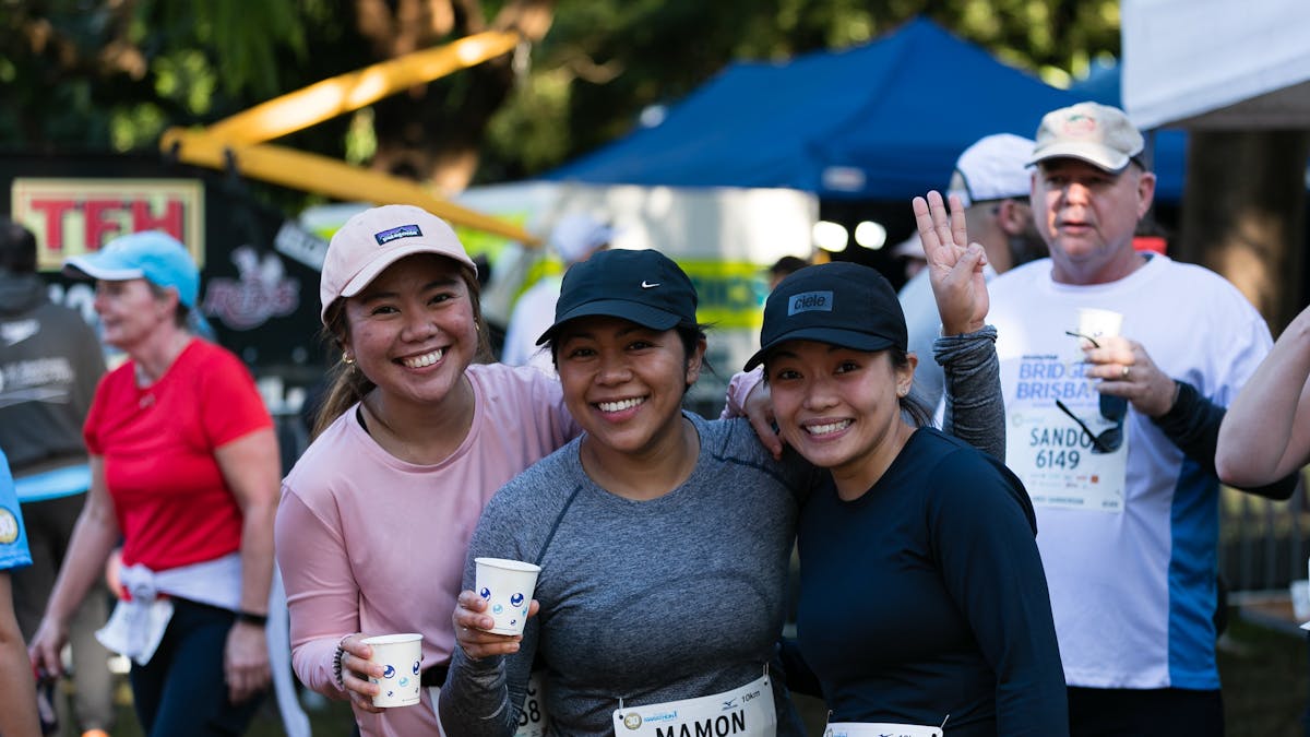 friends after a run holding water cups
