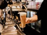 Pouring a schooner of beer from bar taps