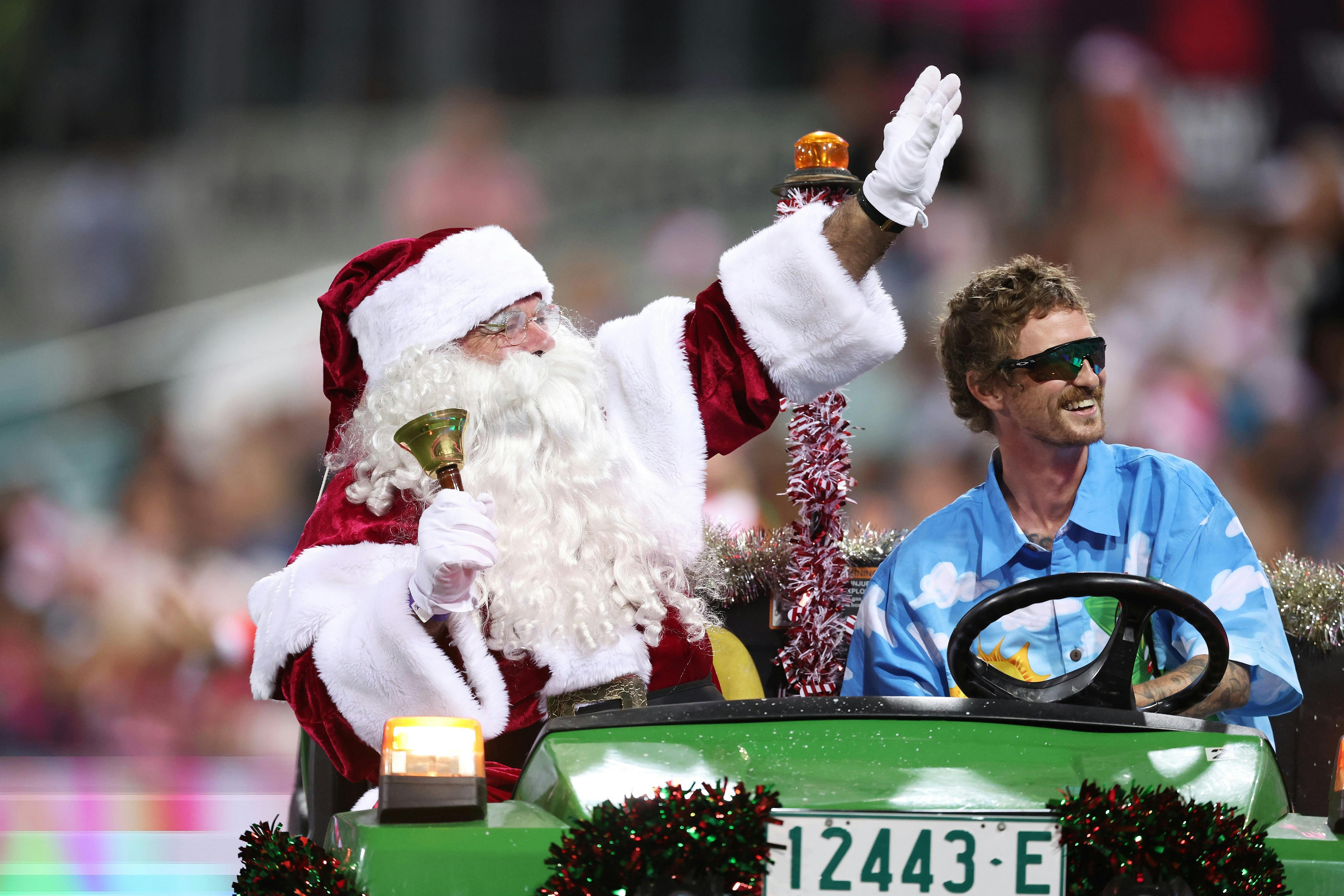 Santa rides on the groundskeeper buggy to greet all the attendees at the Christmas at the Sixers.
