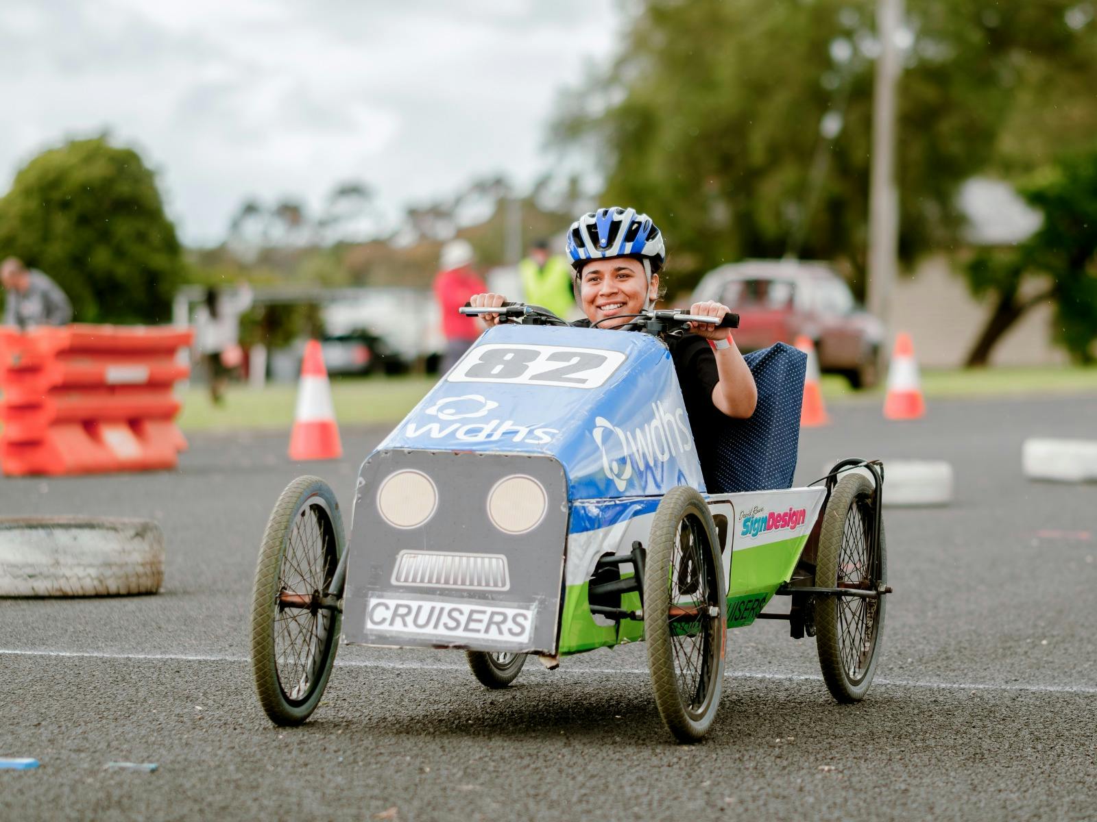 Person in a blue and green Pedal Car