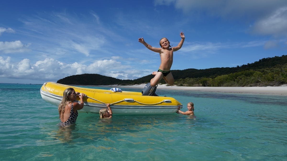 Kids having fun Whitehaven Beach swimming tender