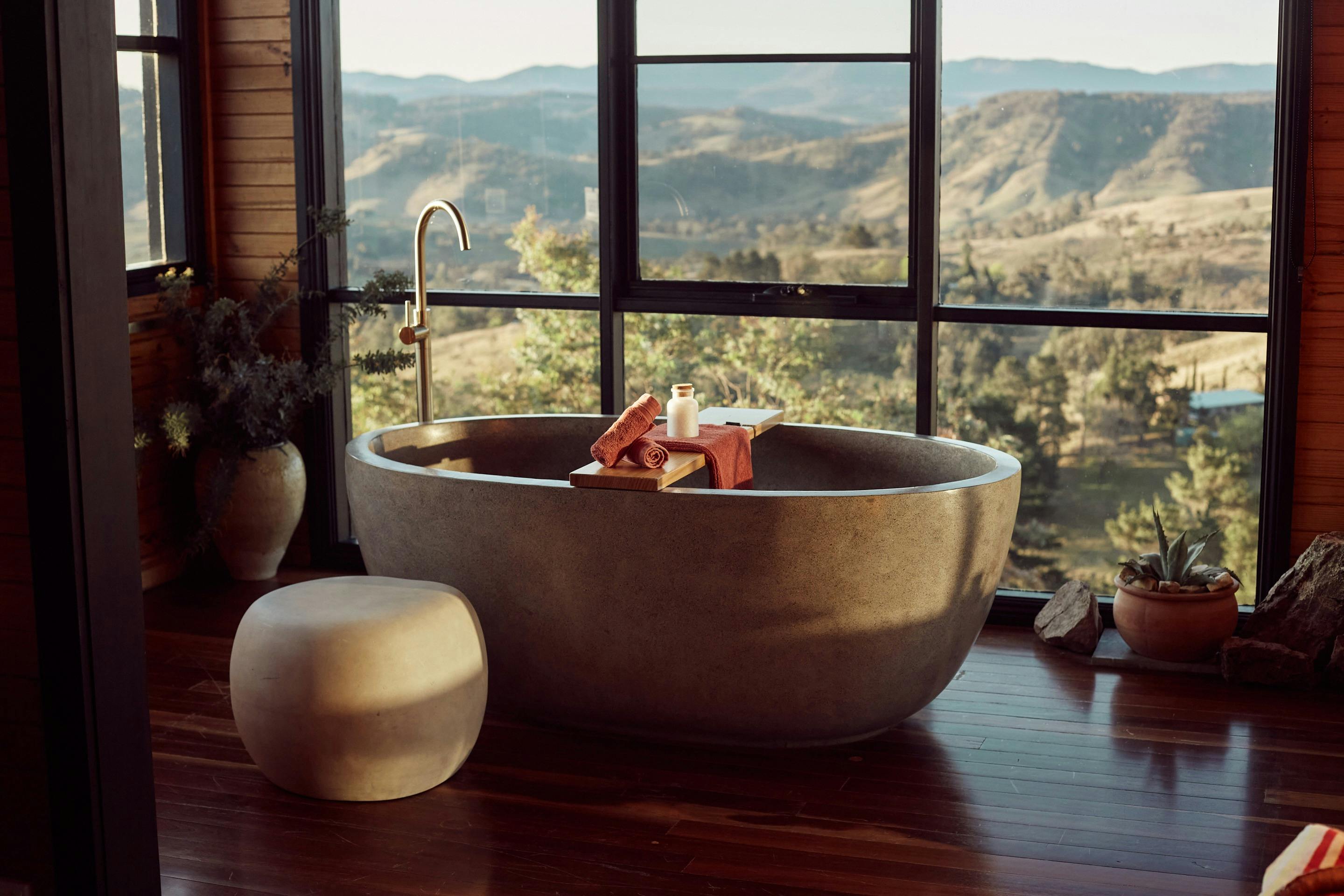 Stone bathtub with amazing views and floor to ceiling windows