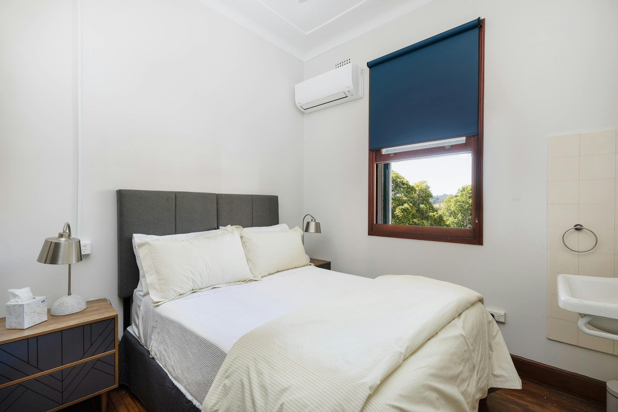 Double bed white linen airconditioner view from window