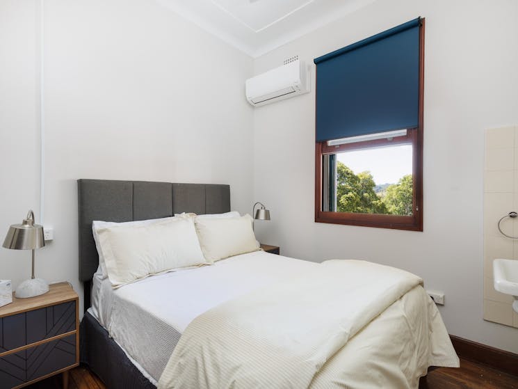 Double bed white linen airconditioner view from window
