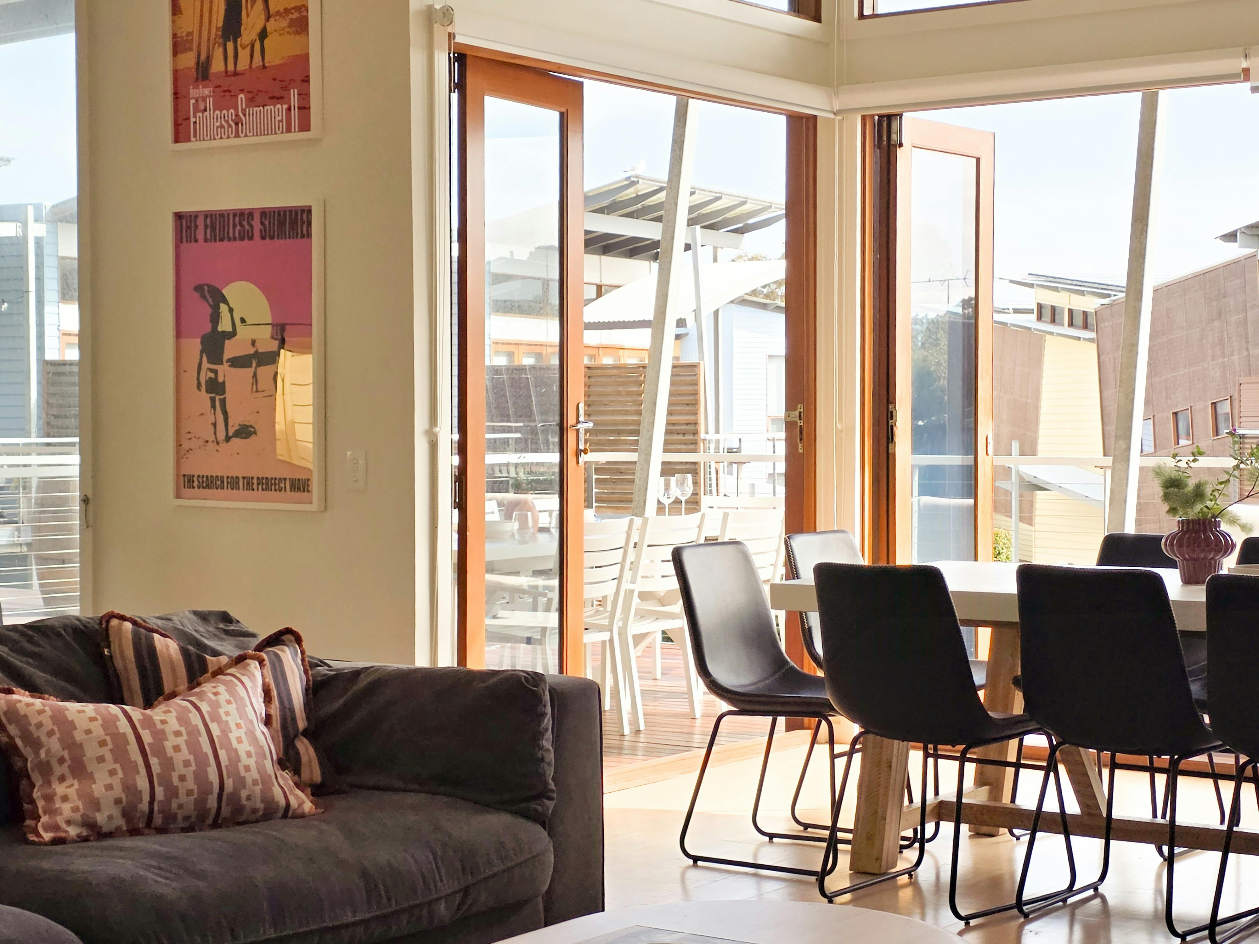 Large open plan kitchen, dining, lounge that opens up to the large deck at Villa 95 by The Shores