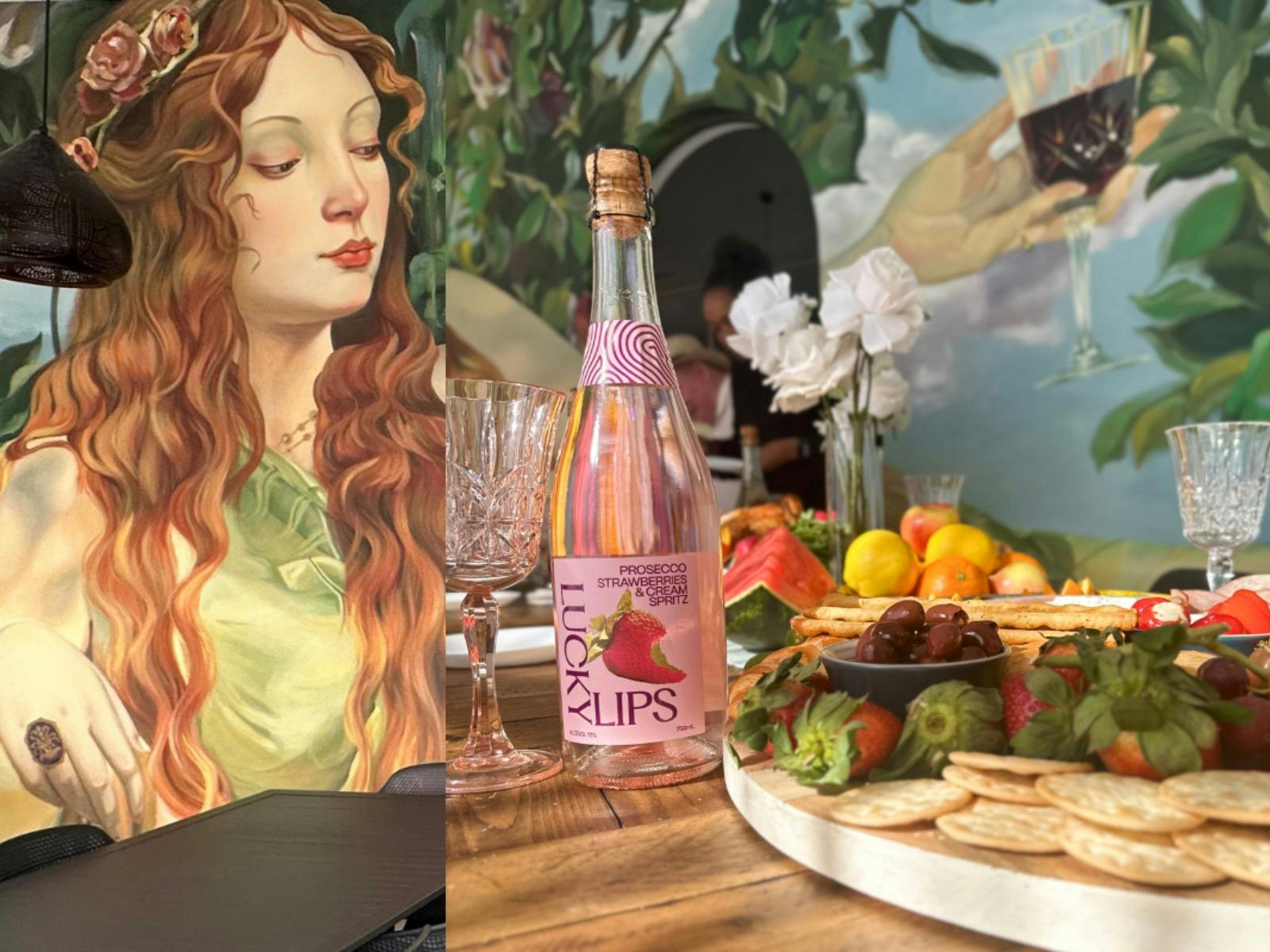 Inside the Meditrina Cellar Door and Cafe, showing the mural, an antipasto platter & sparkling wine