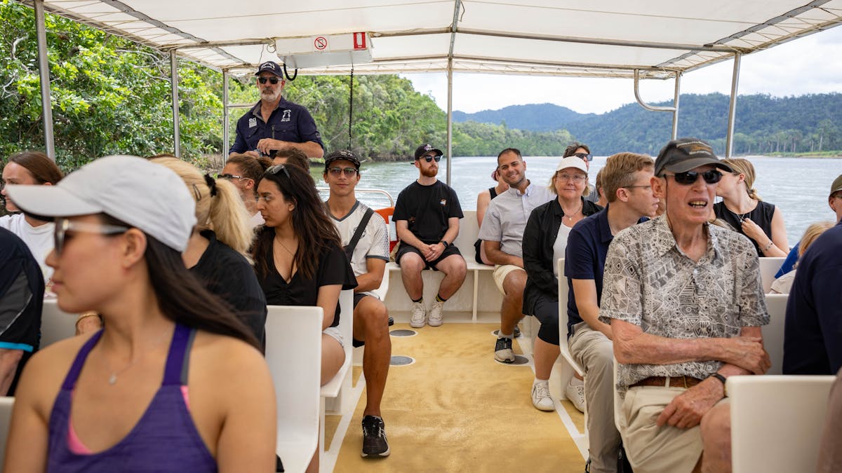 Full boat of guests as tour guide navigates the Daintree River looking for wildlife like Crocodiles
