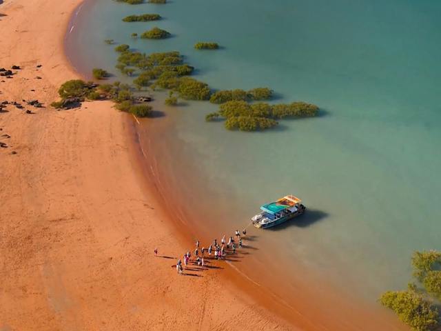 Aerial shot of tour guests boarding Brahminy Kite from Simpson beach.