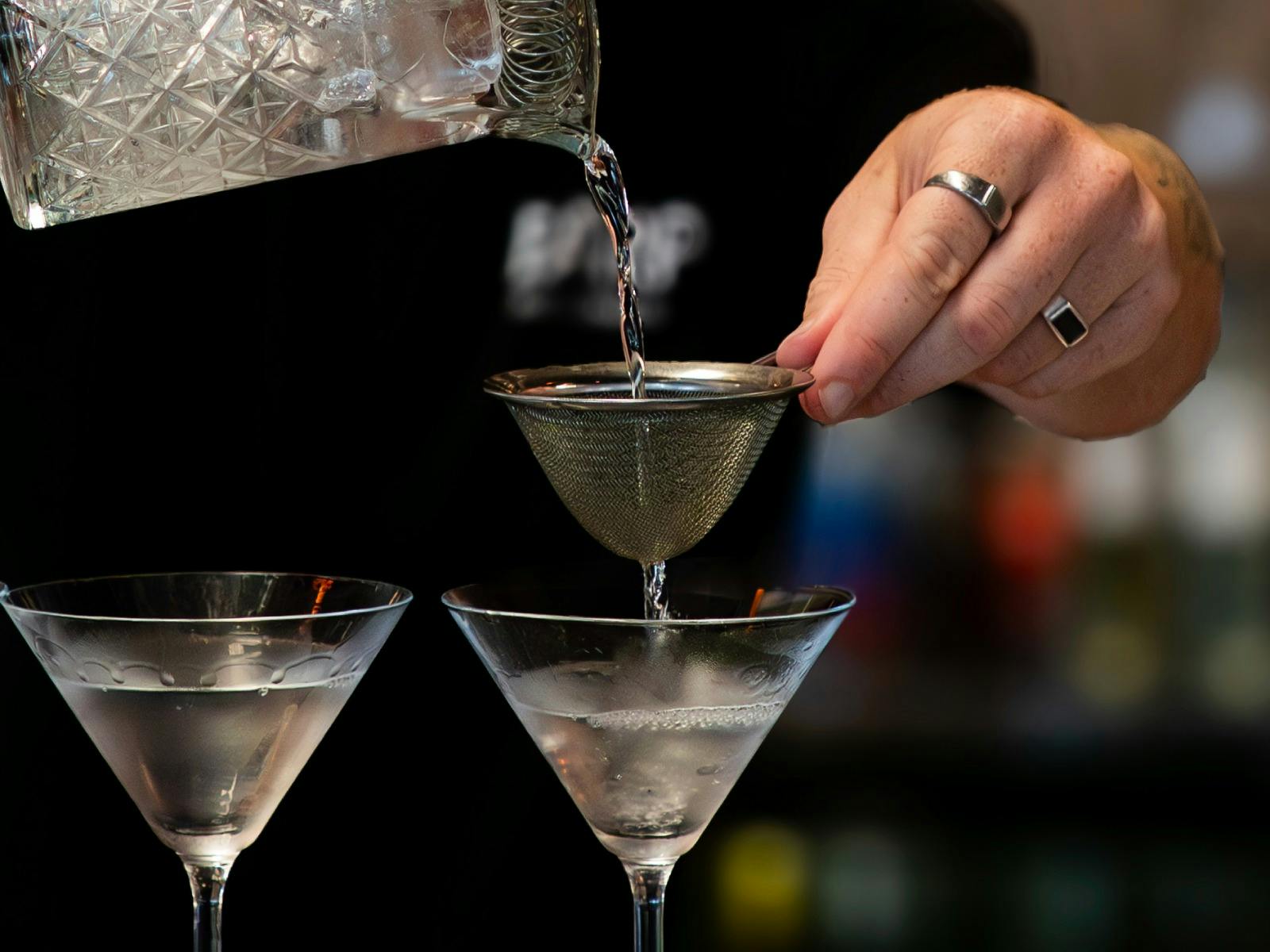 An Earp Distillery staff member expertly pours chilled martinis