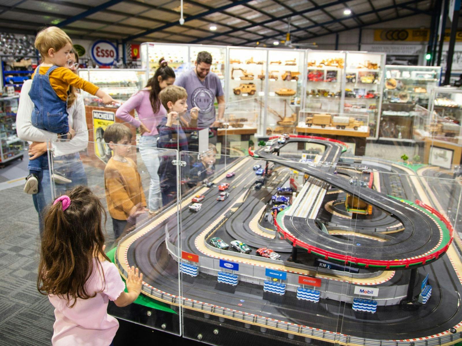 Parents and children looking at Scalextric