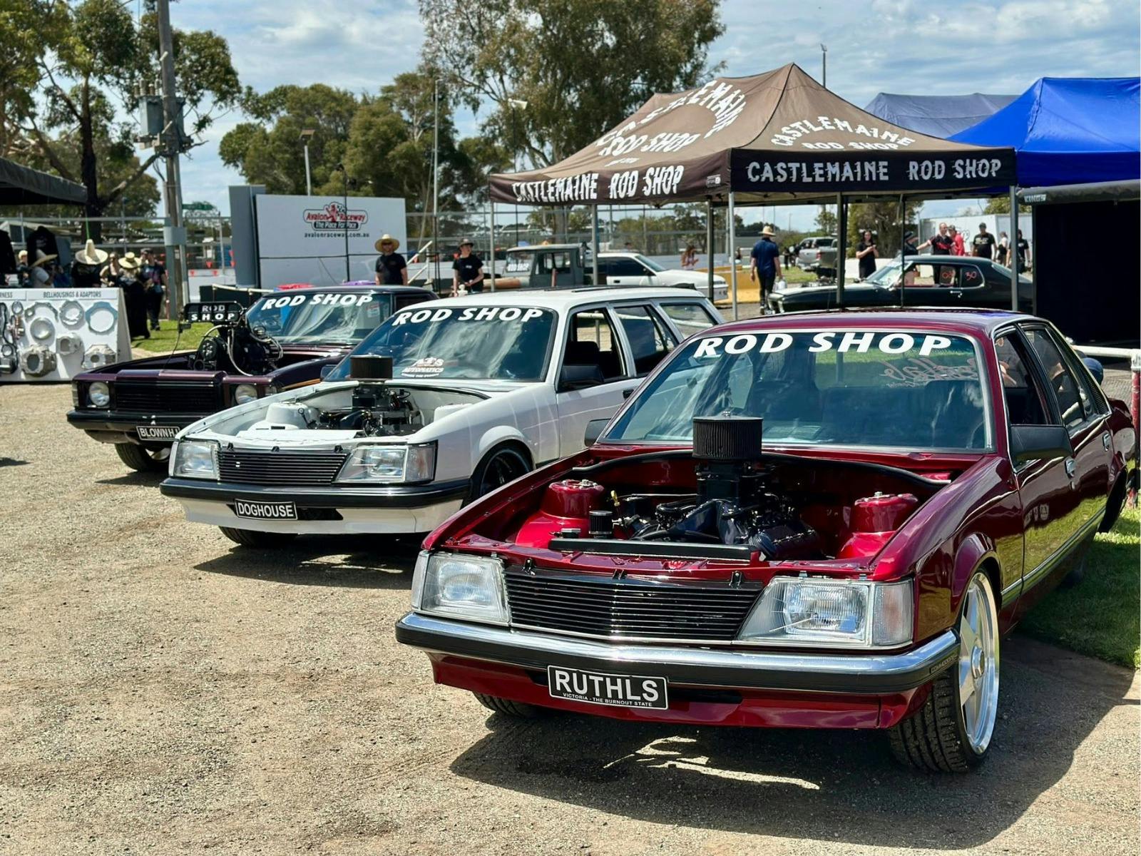 Four modified burnout cars on display beside the Castlemaine Rod Shop marquee.