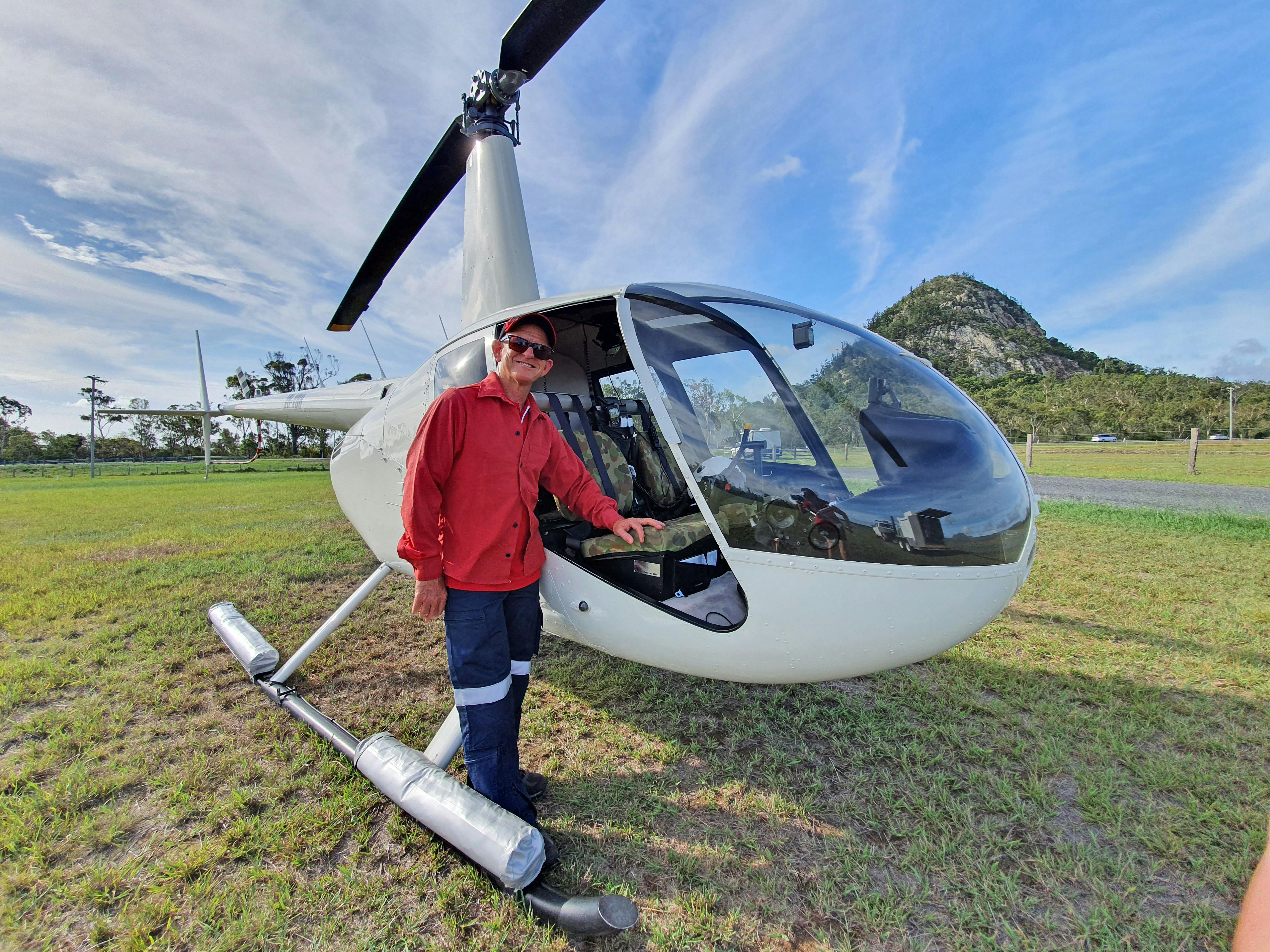 Photo of pilot and helicopter