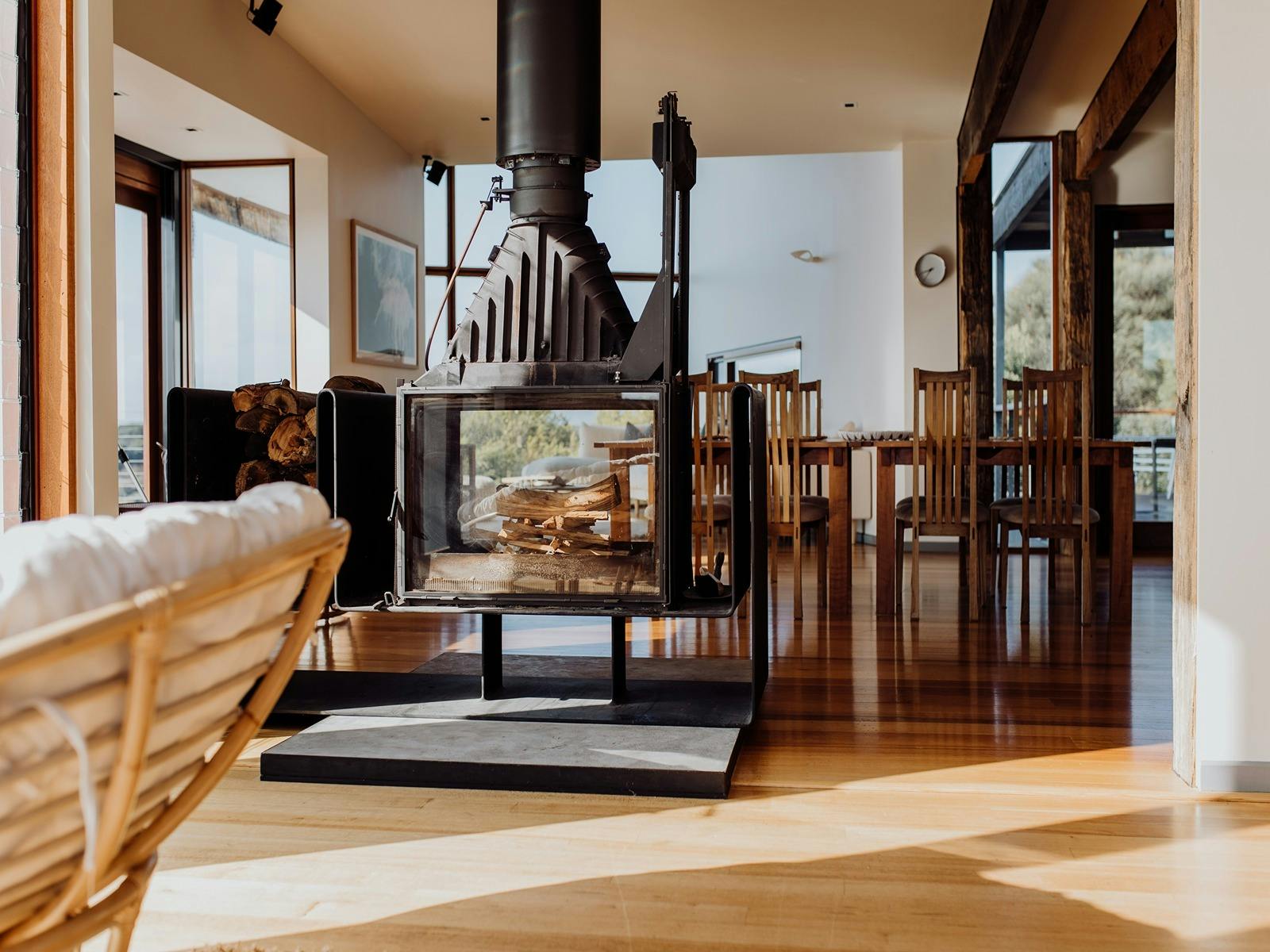 Sitting area overlooking the ocean, fireplace and dining space.