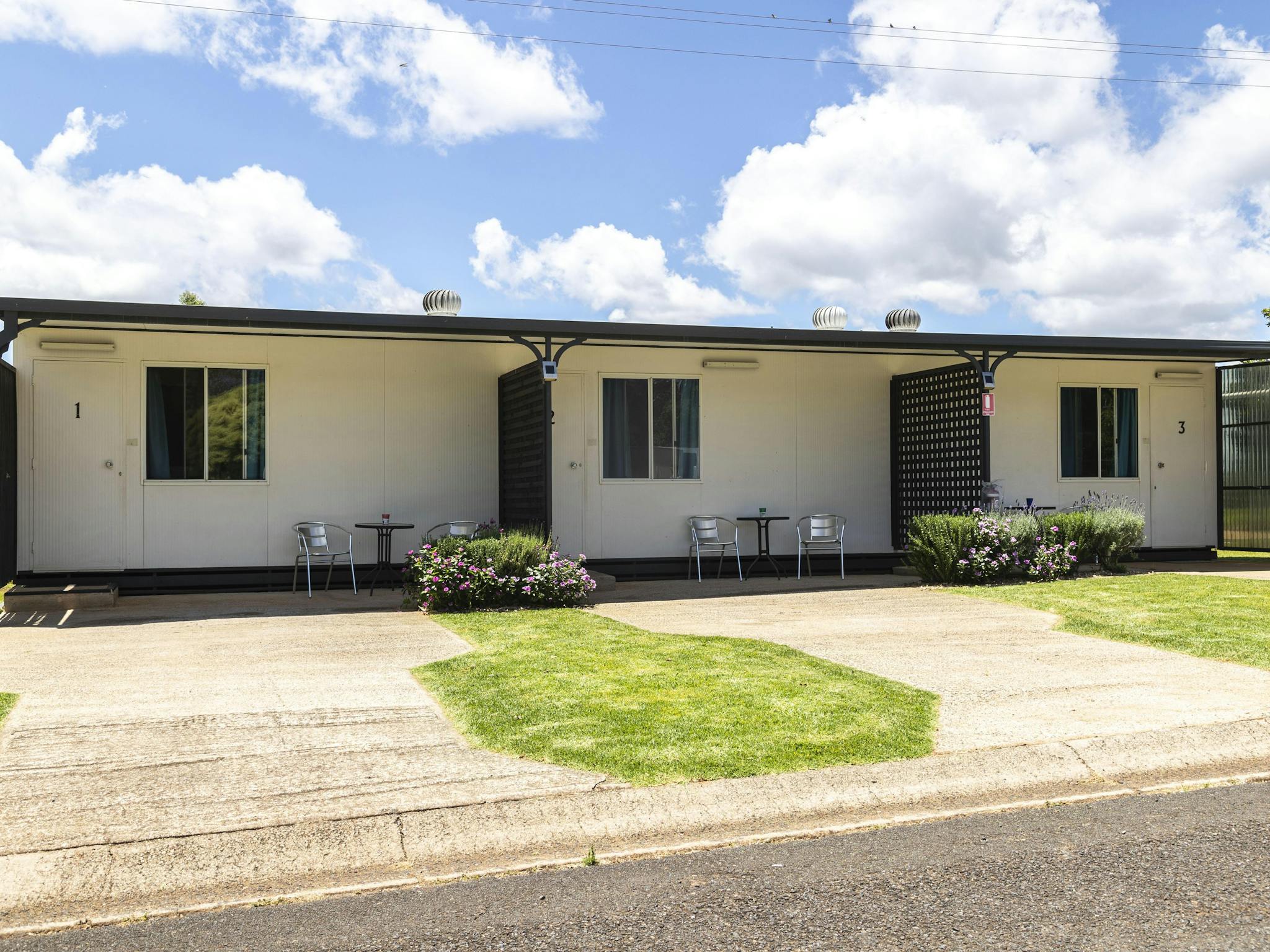 Exterior of Standard Cabins with outdoor seating and gardens. Exterior of Standard Cabins with outdoor seating and gardens.
