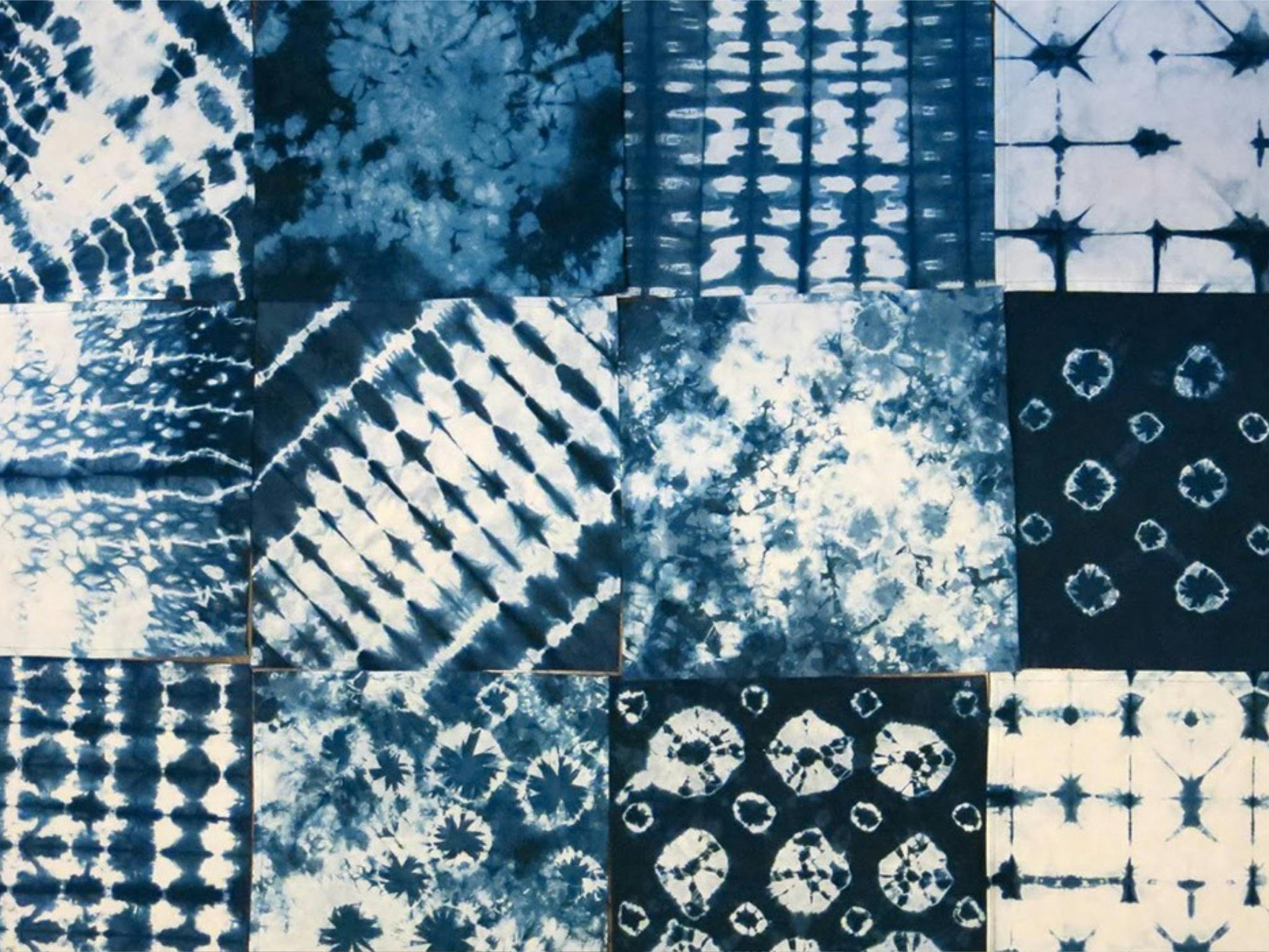 a range of indigo dyed fabrics using the shibori technique