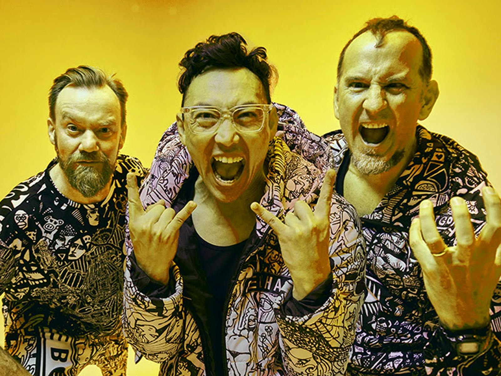 A photo of 3 members of Regurgitator wearing matching outfits and looking directly into the camera