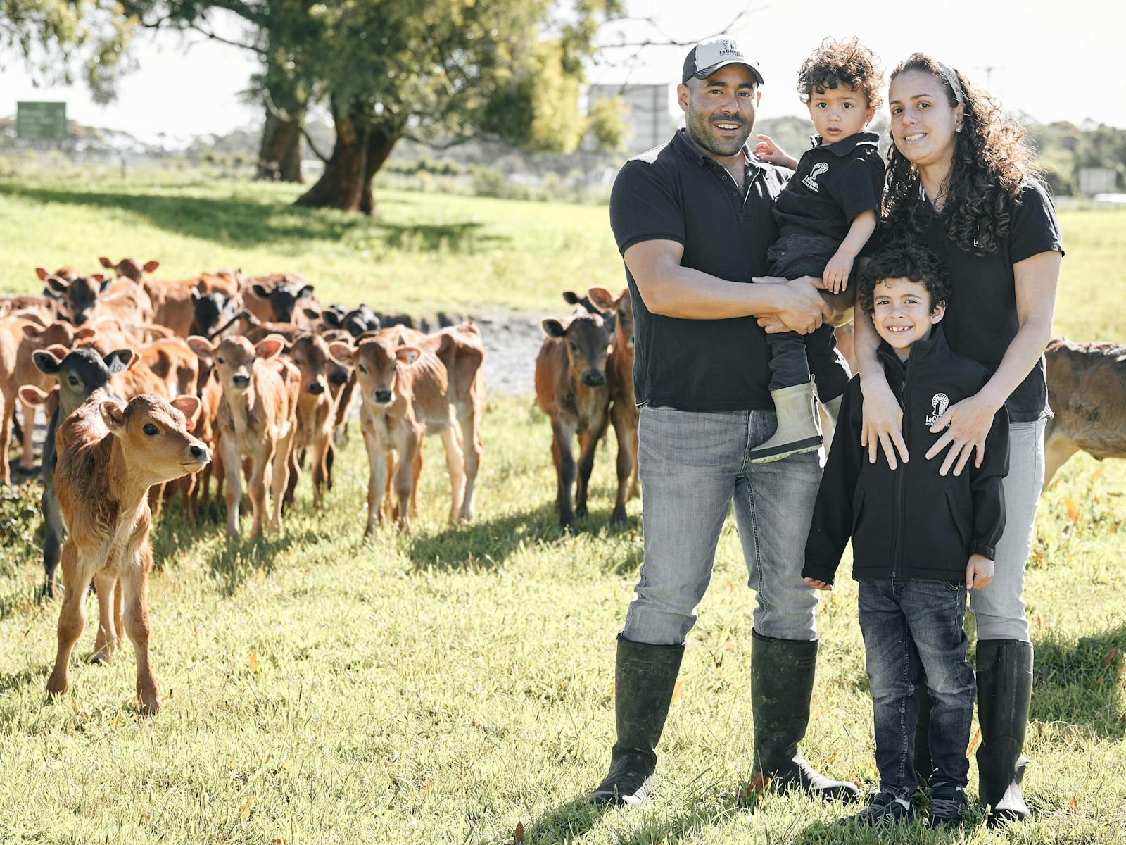 The cheese makers family in the paddock with young calves.