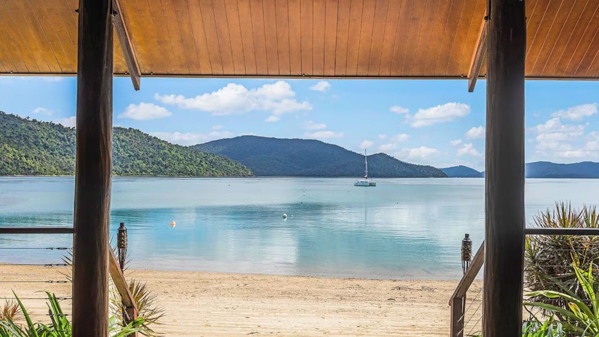 Hut on beach with mountains in foreground