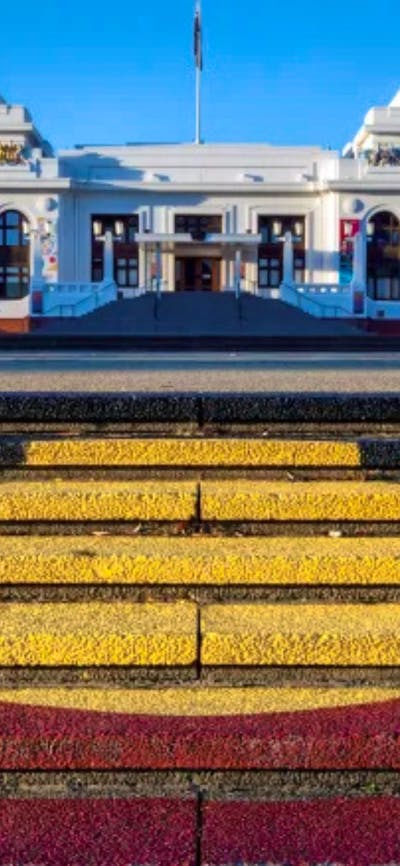 The Aboriginal flag painted on the steps in front of Old Parliament House