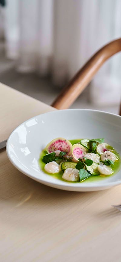 A dish of scallops and a glass of wine