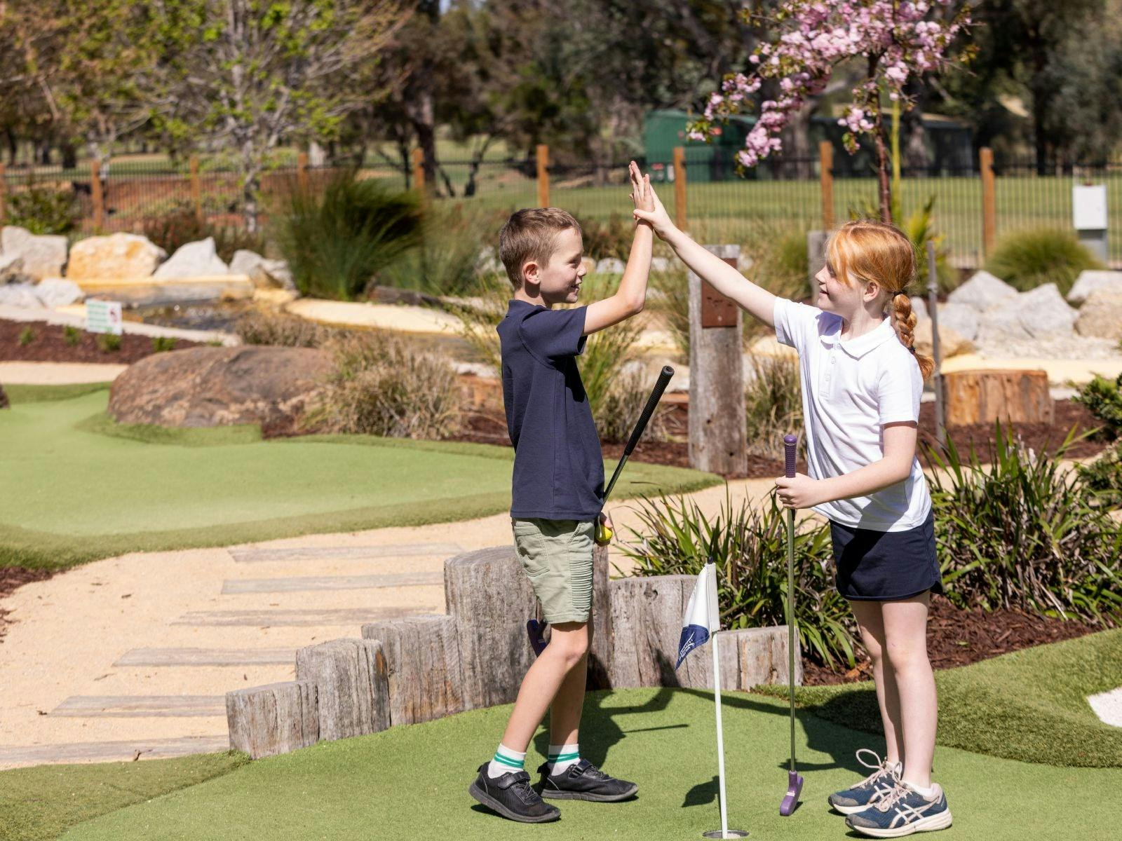Two kids giving each other high five