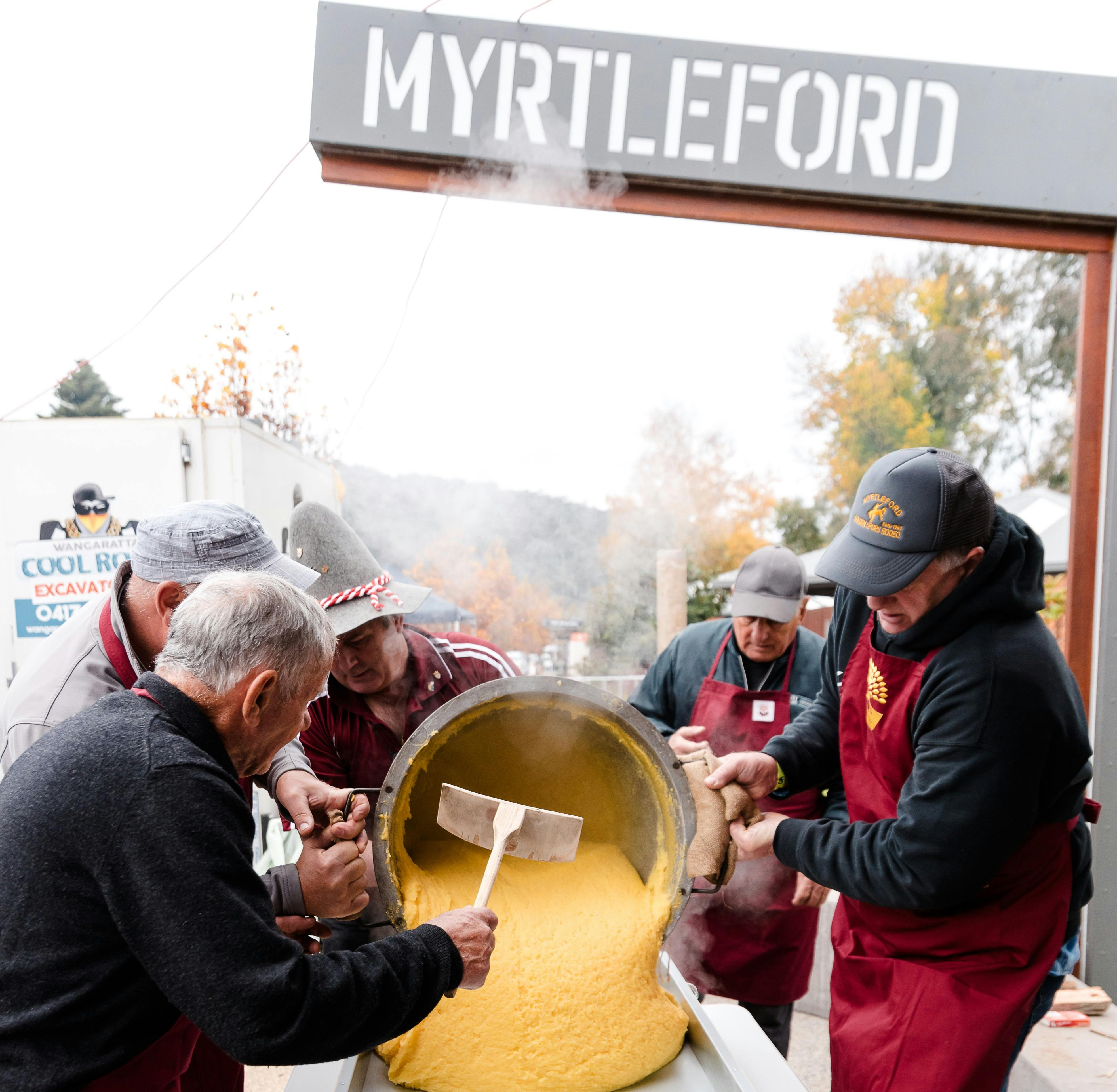 Trentini men pouring polenta
