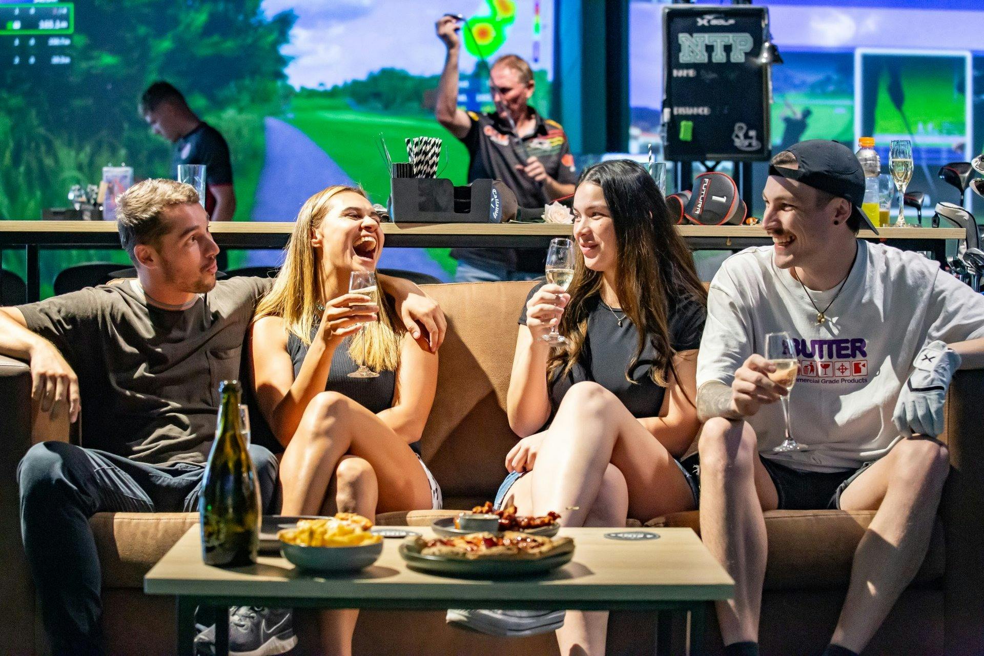 Friends enjoying a night out at X-Golf Penrith