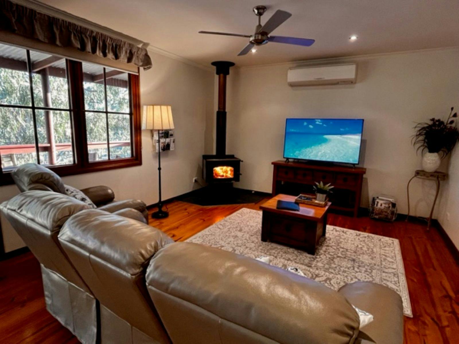 Lounge area with flat screen TV and wood fire