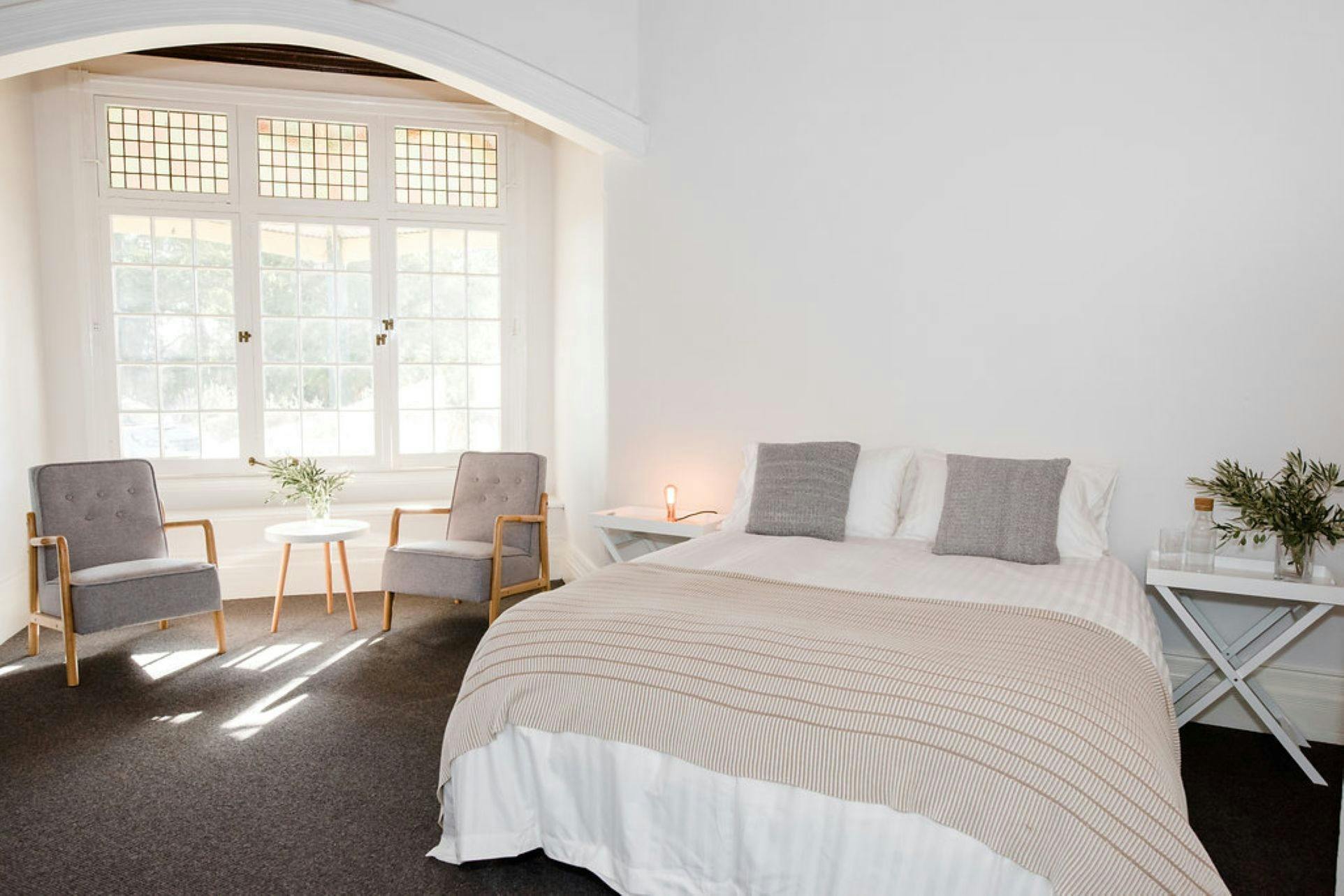 The Residence, Rutherglen bedroom with bed, bedside table, chairs and small table