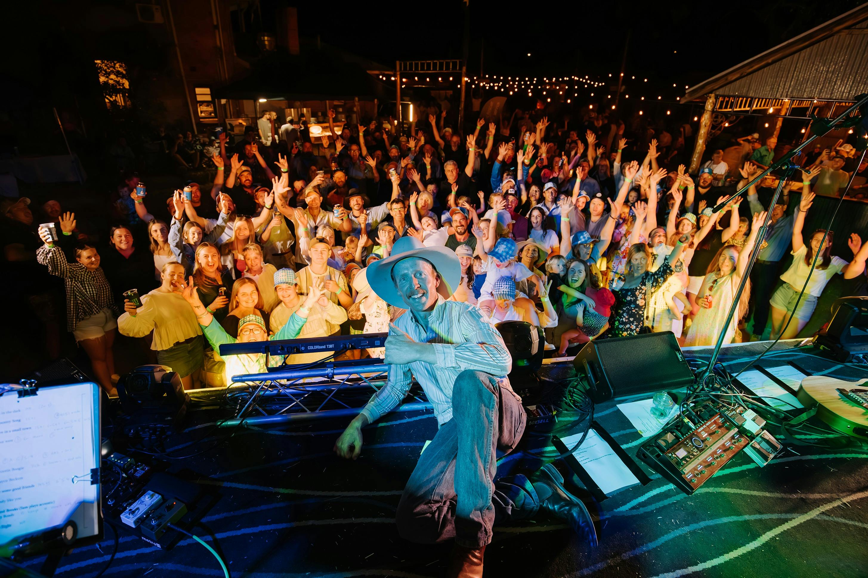 Sam Snape on stage at Boggabri with crowd in the background