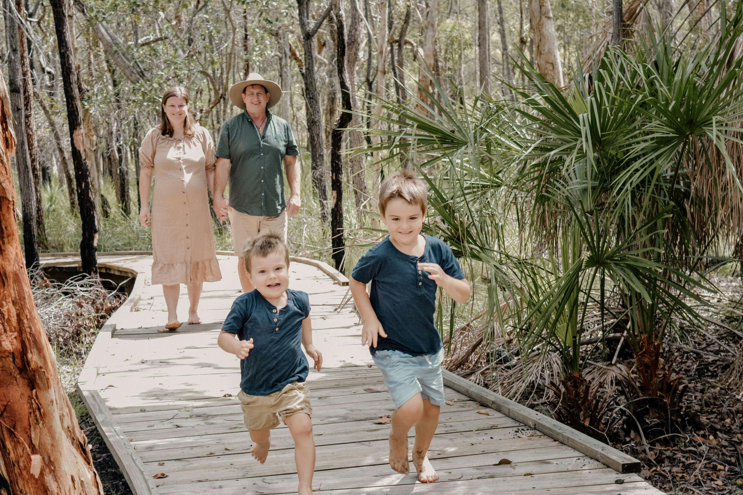 Family walking along the bushland boardwalk at Traveller's Rest 1770 BushTracks Eco Tours in 1770