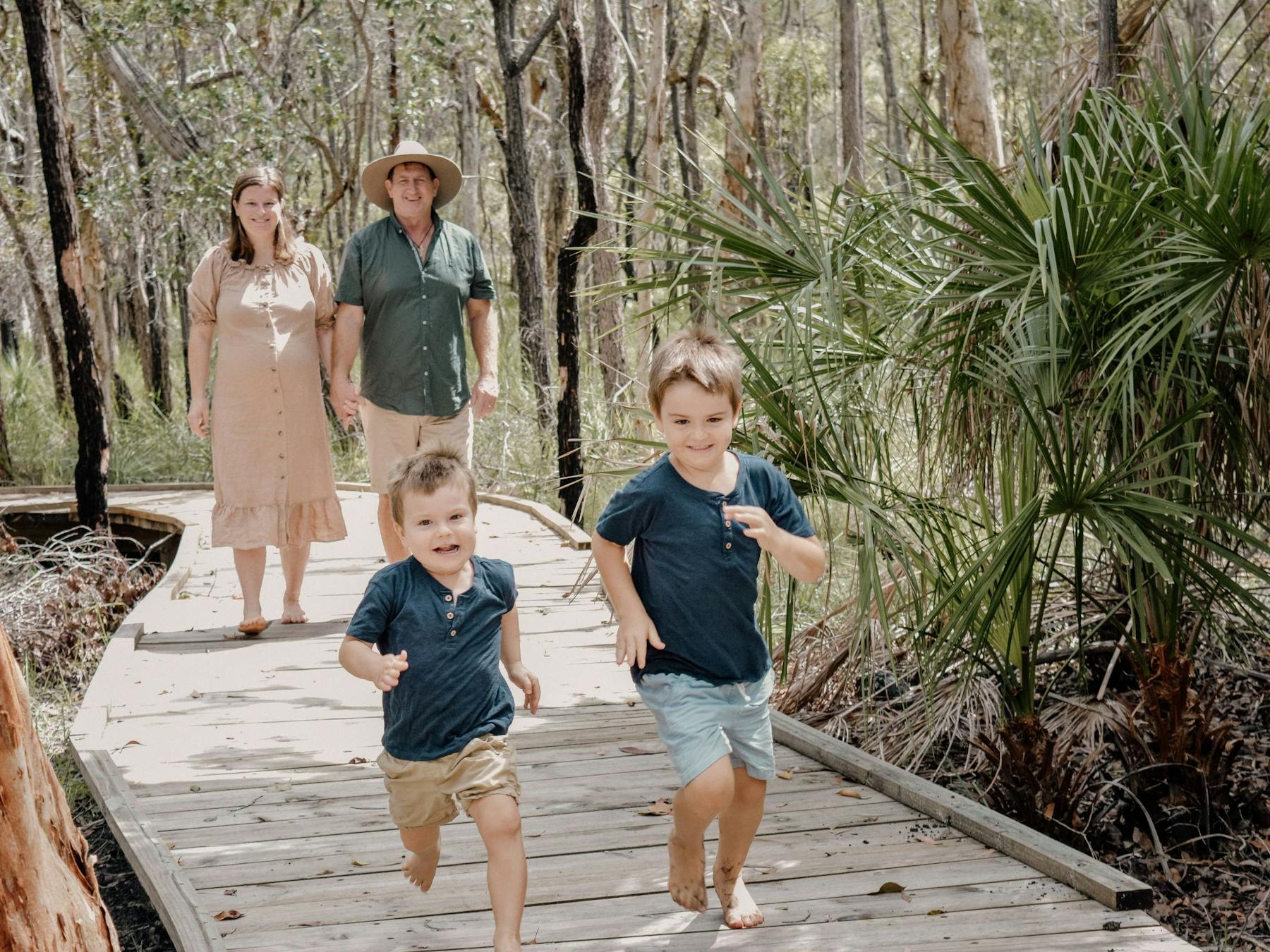 Family walking along the bushland boardwalk at Traveller's Rest 1770 BushTracks Eco Tours in 1770