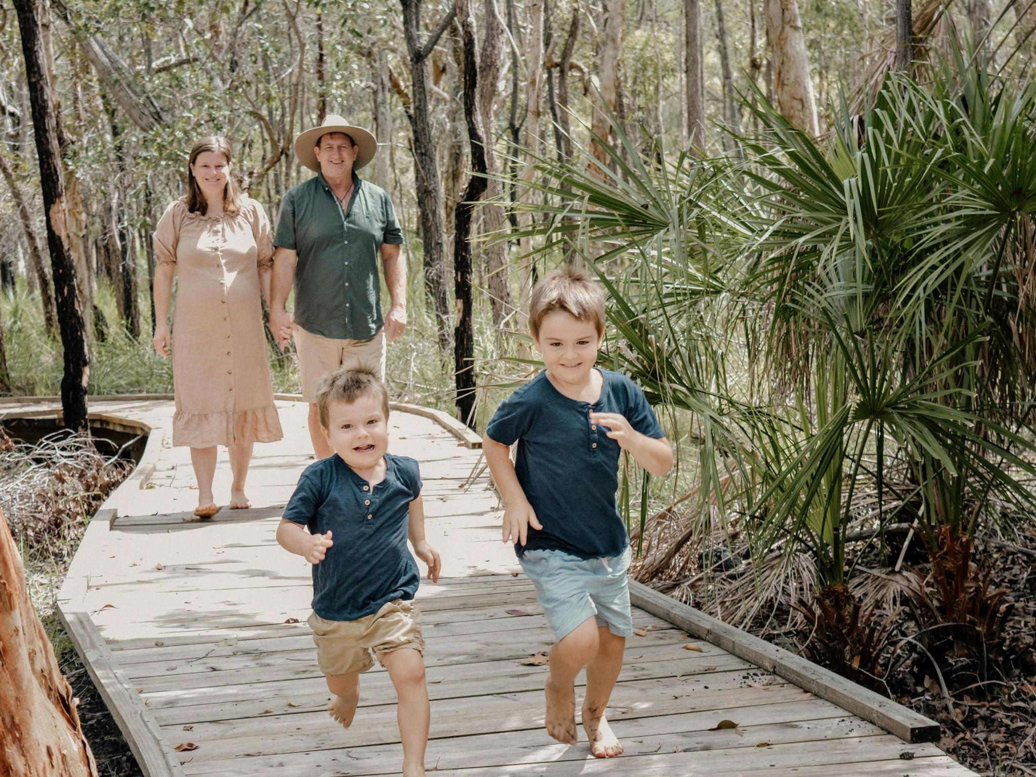 Family walking along the bushland boardwalk at Traveller's Rest 1770 BushTracks Eco Tours in 1770