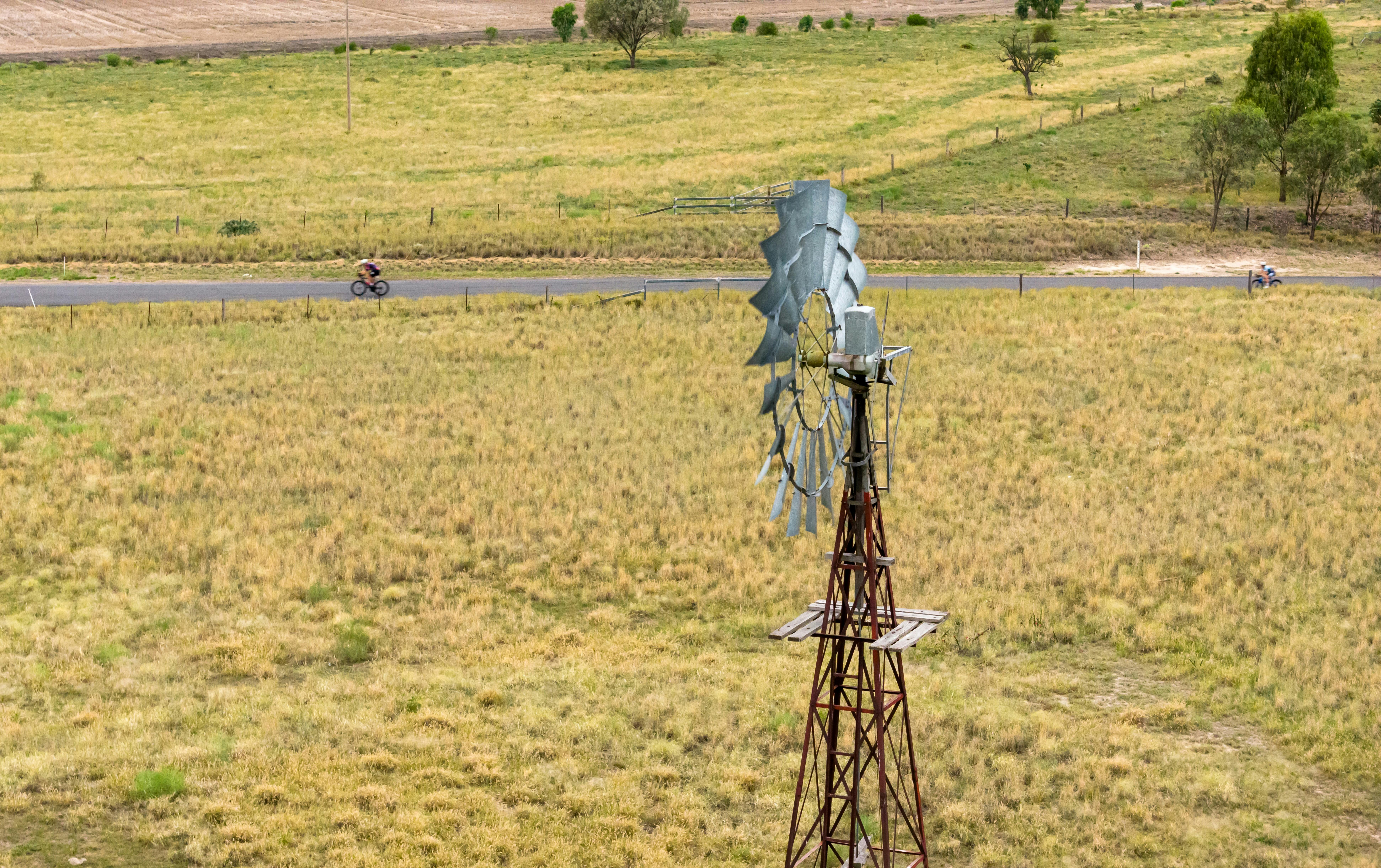 drone photo of windmill and cyclist