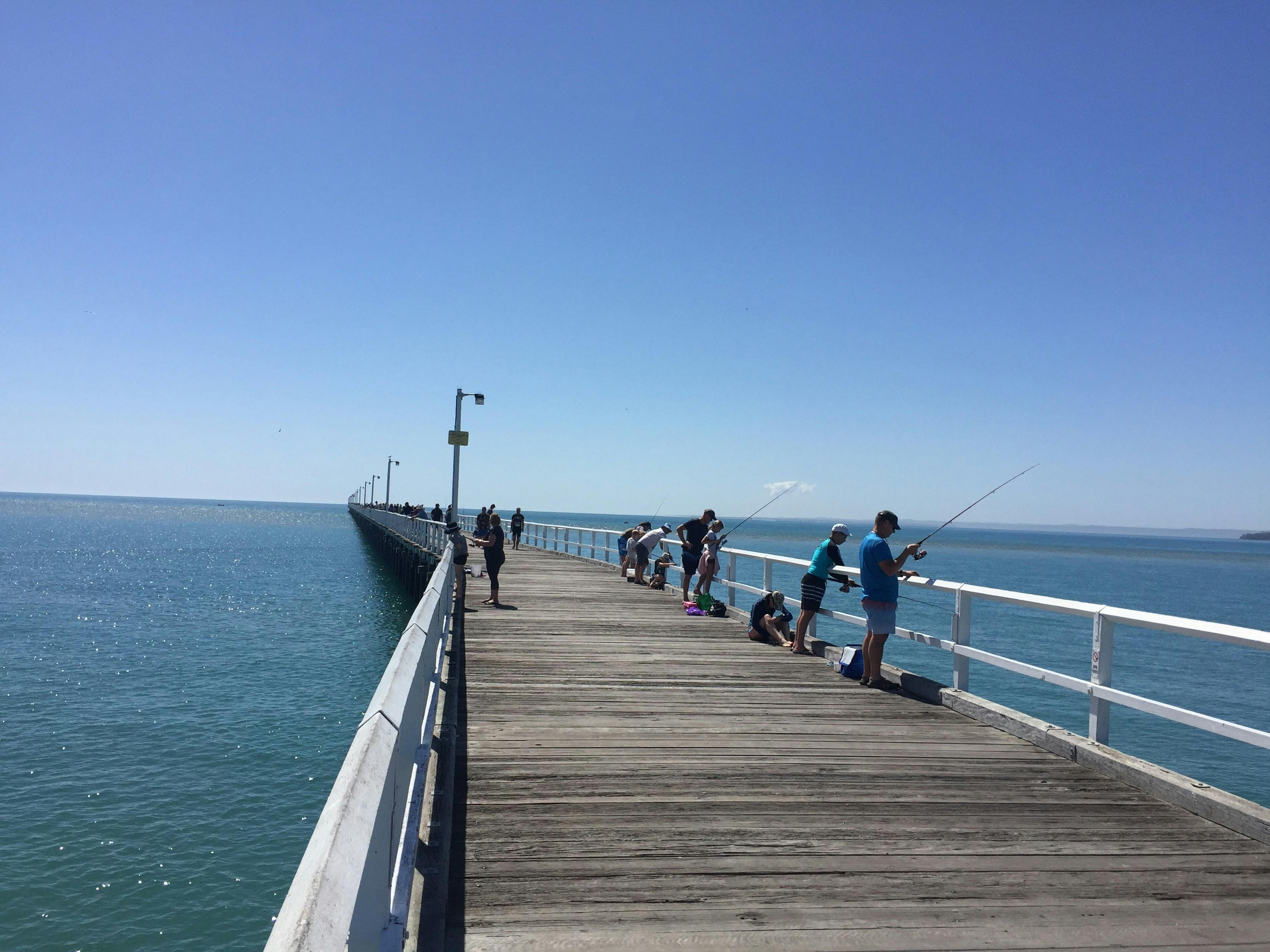 photo showing poeple fishing from Urangan Pier