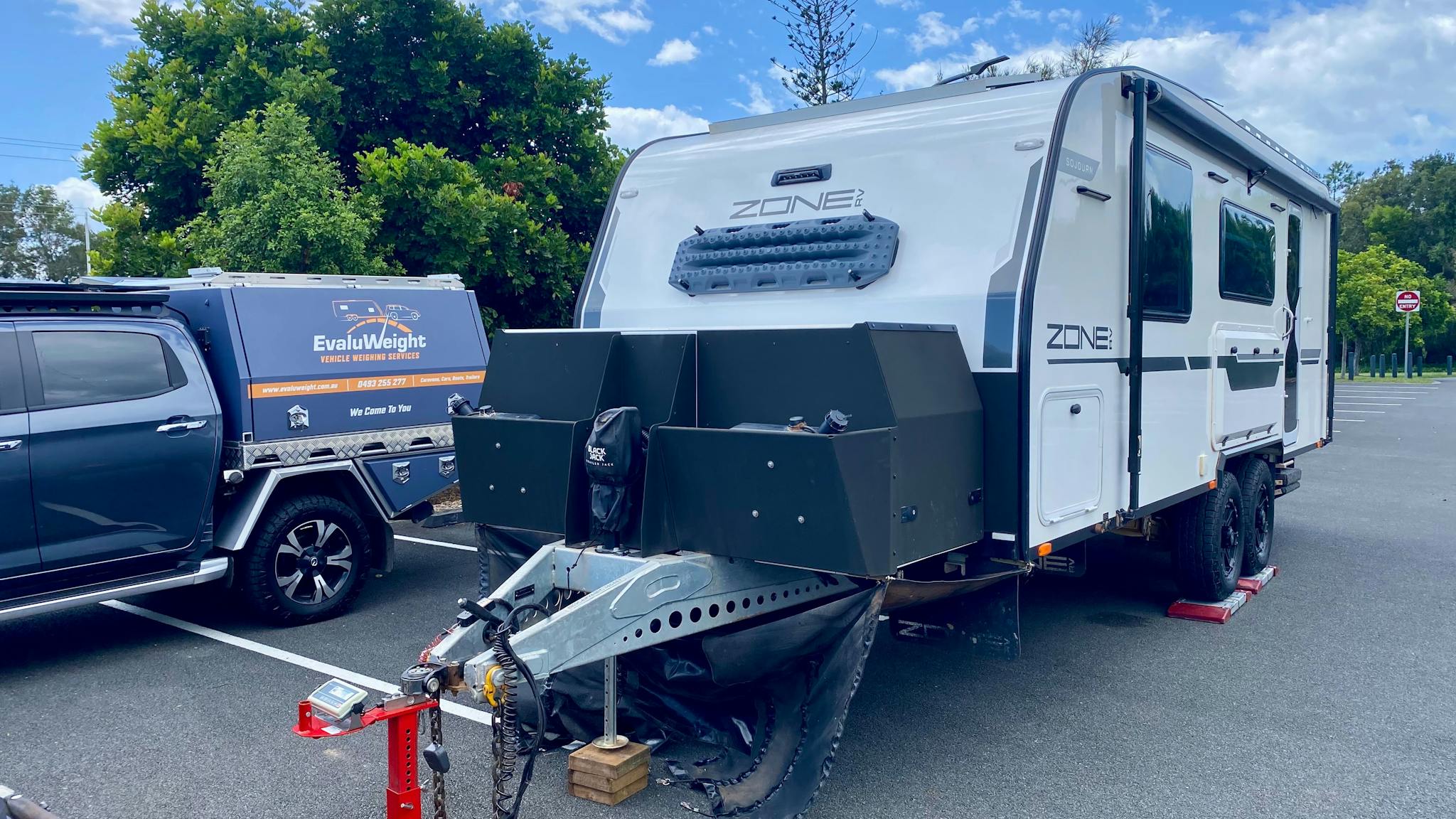 EvaluWeight branded vehicle and caravan being weighed EvaluWeight branded vehicle and caravan being weighed