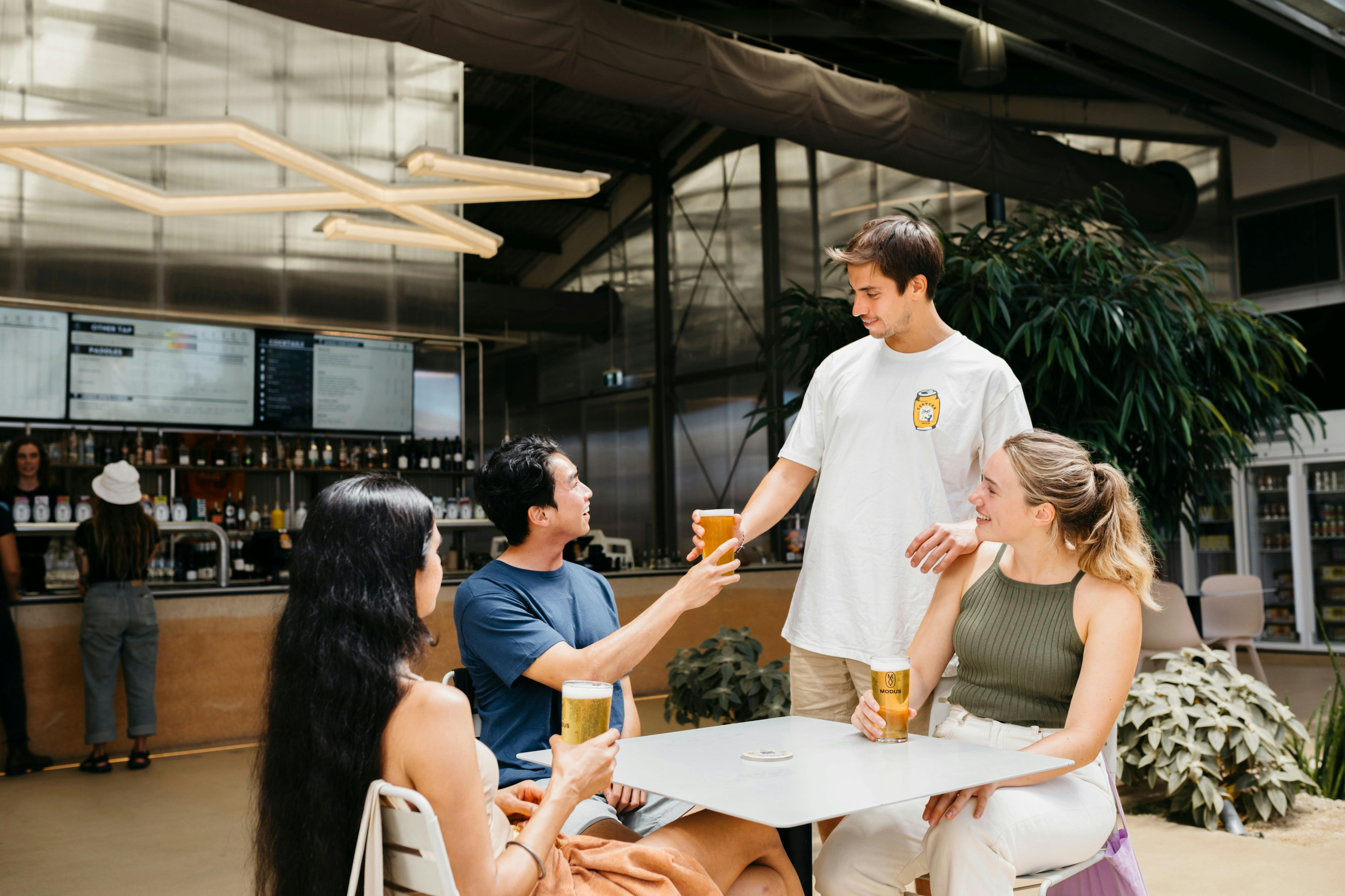 Young people visiting Modus Brewery in Newcastle and enjoying a drink together